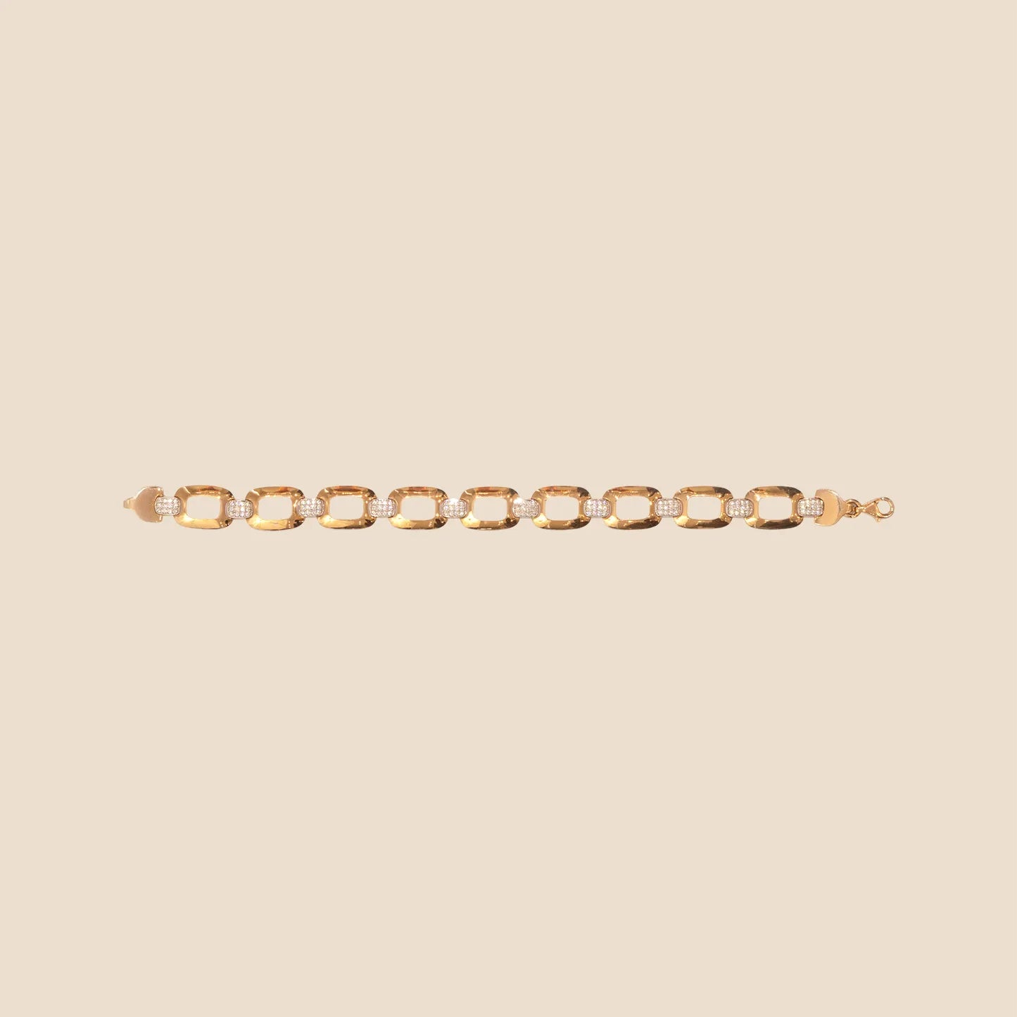 Gold bracelet on a beige background