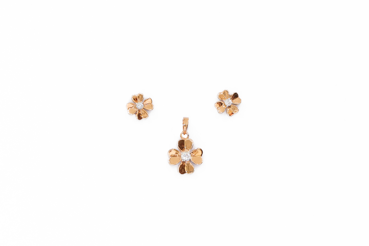Gold flower-shaped jewelry set with pendant and earrings on a white background