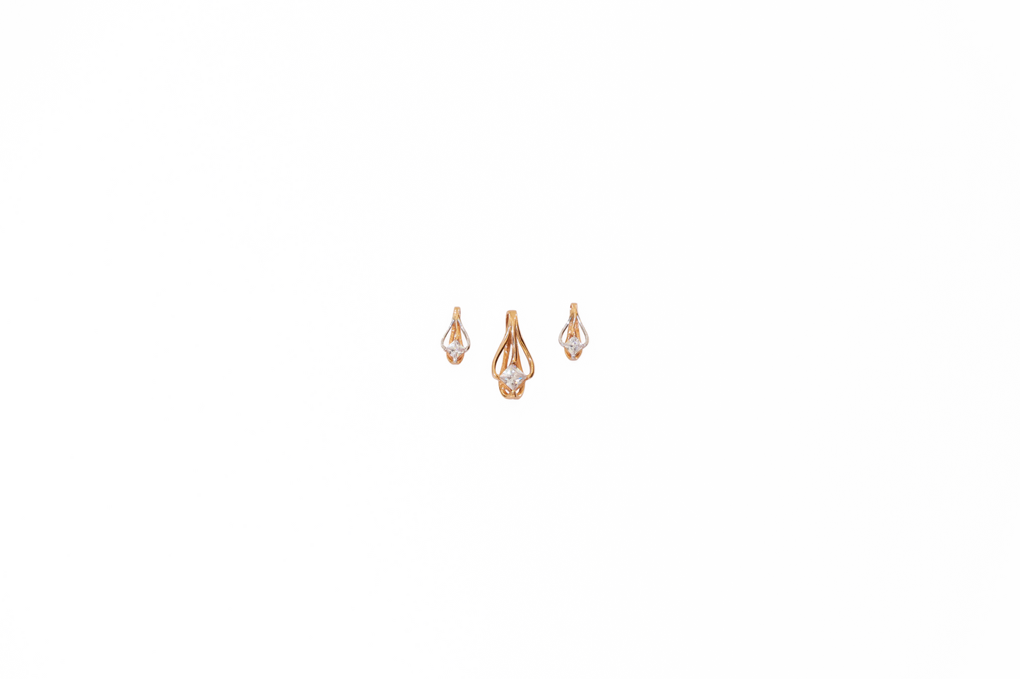 Pair of rose gold earrings with clear gemstones on a white background
