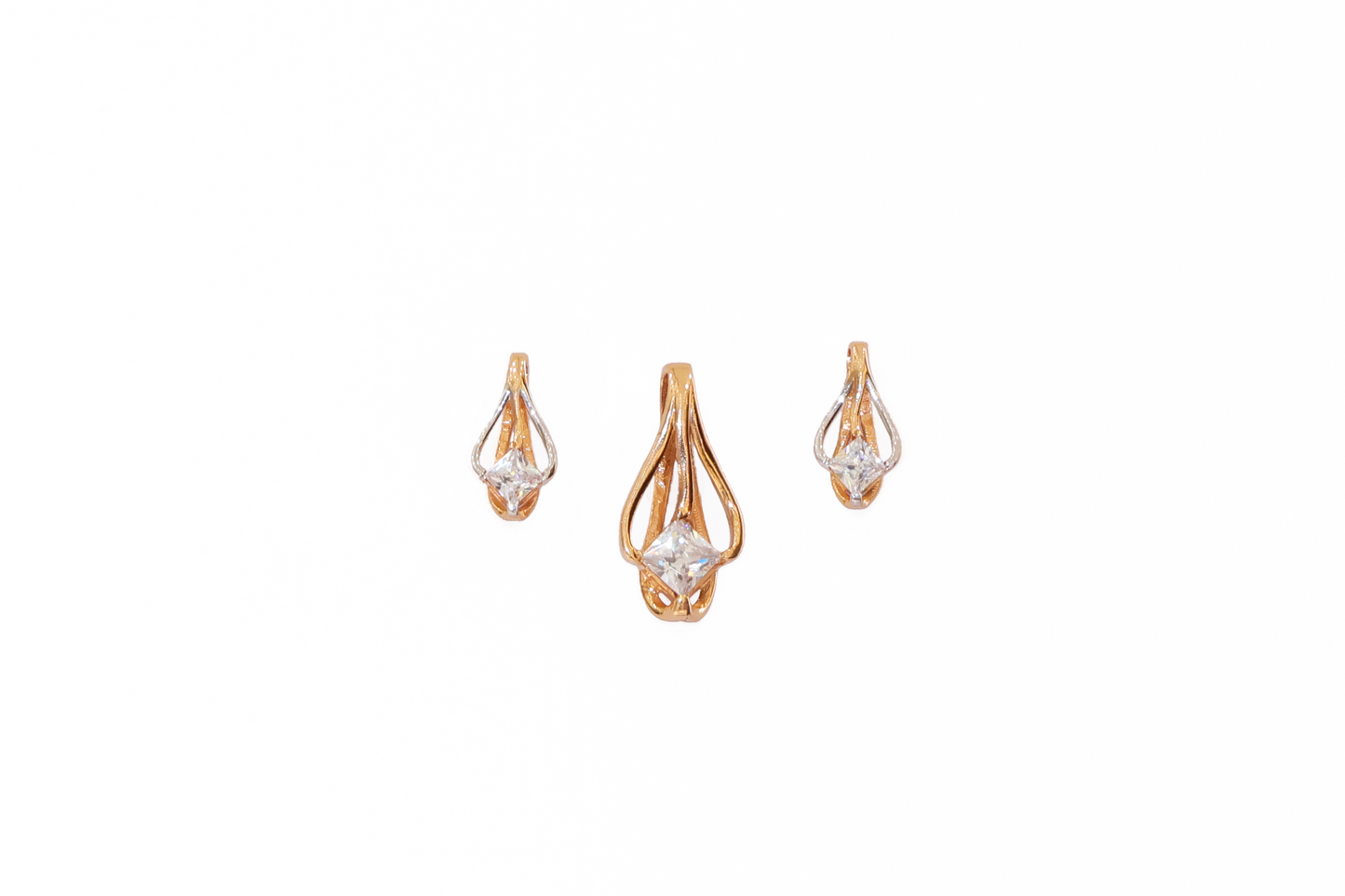 Gold earrings with clear stones on a white background