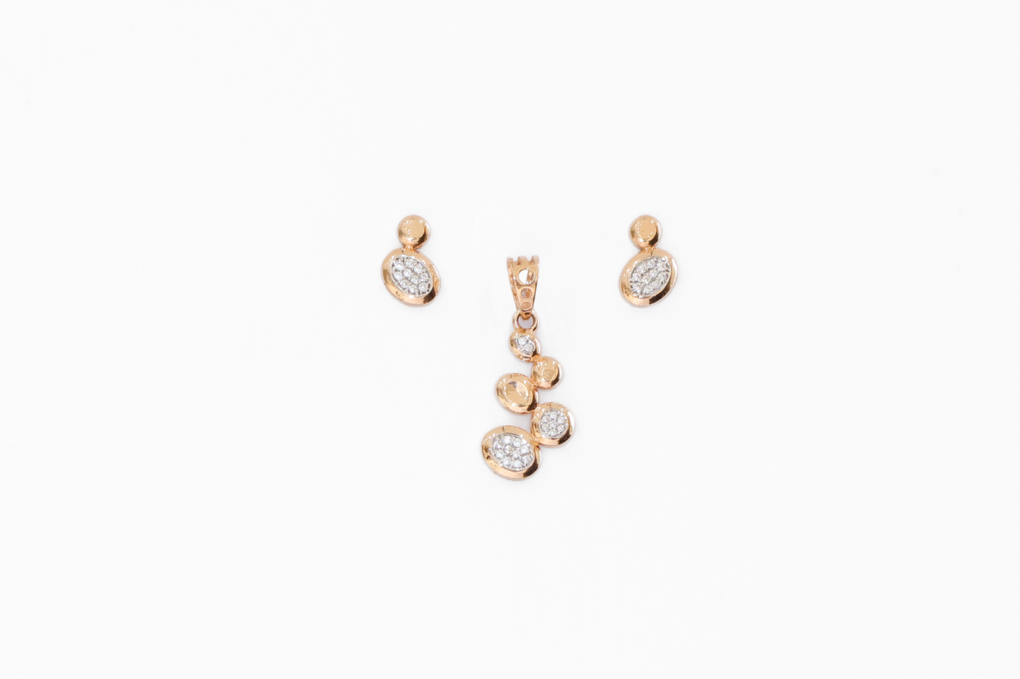 Gold jewelry set with earrings and a necklace on a white background