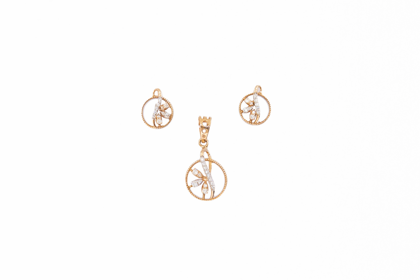 Gold pendant and earrings set on a white background