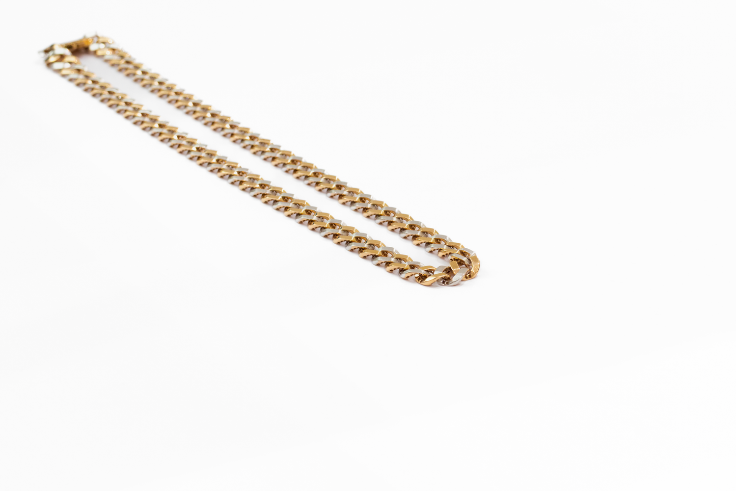 Gold chain necklace on a white background