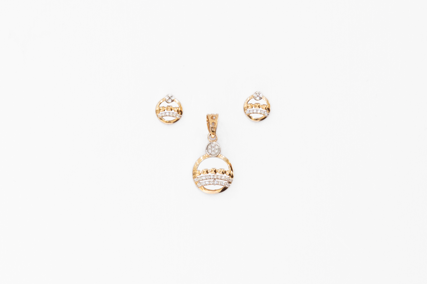 Gold necklace with pendant and matching earrings on a white background