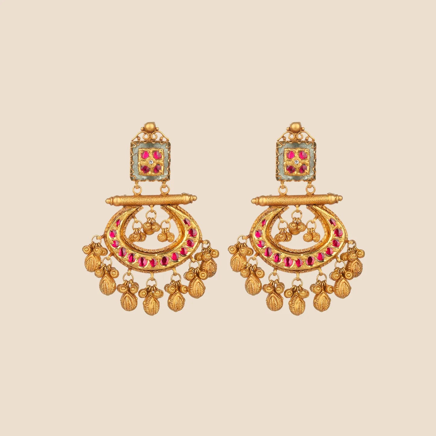 Gold dangle earrings featuring a square top with red stones and a crescent-shaped bottom piece adorned with red stones and gold drop dangles.