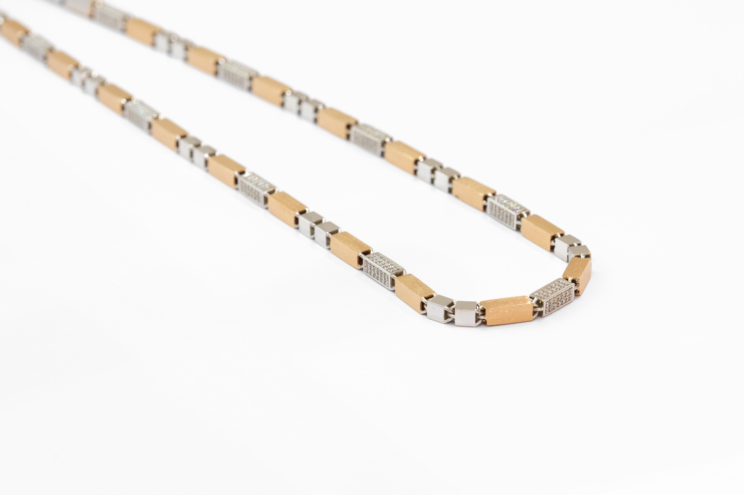 Gold and silver chain necklace on a white background