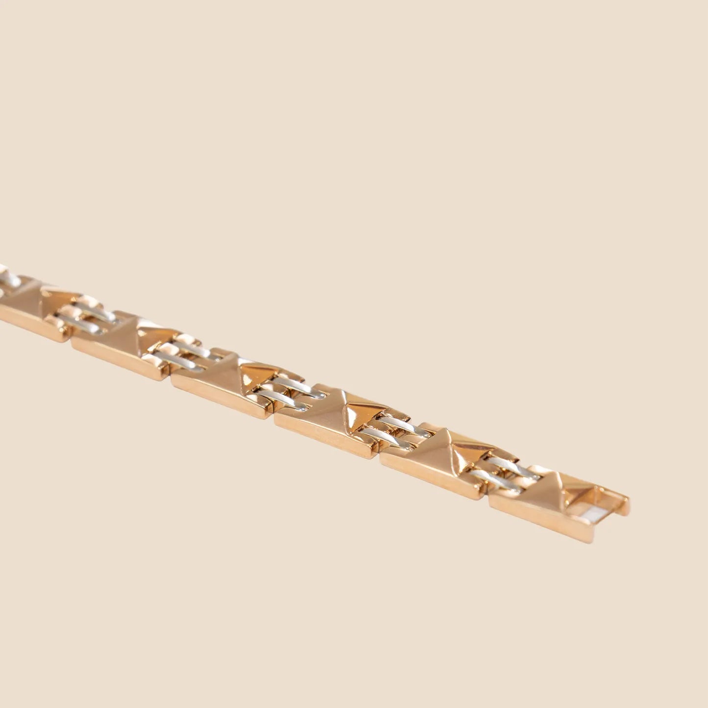 Gold bracelet on a beige background