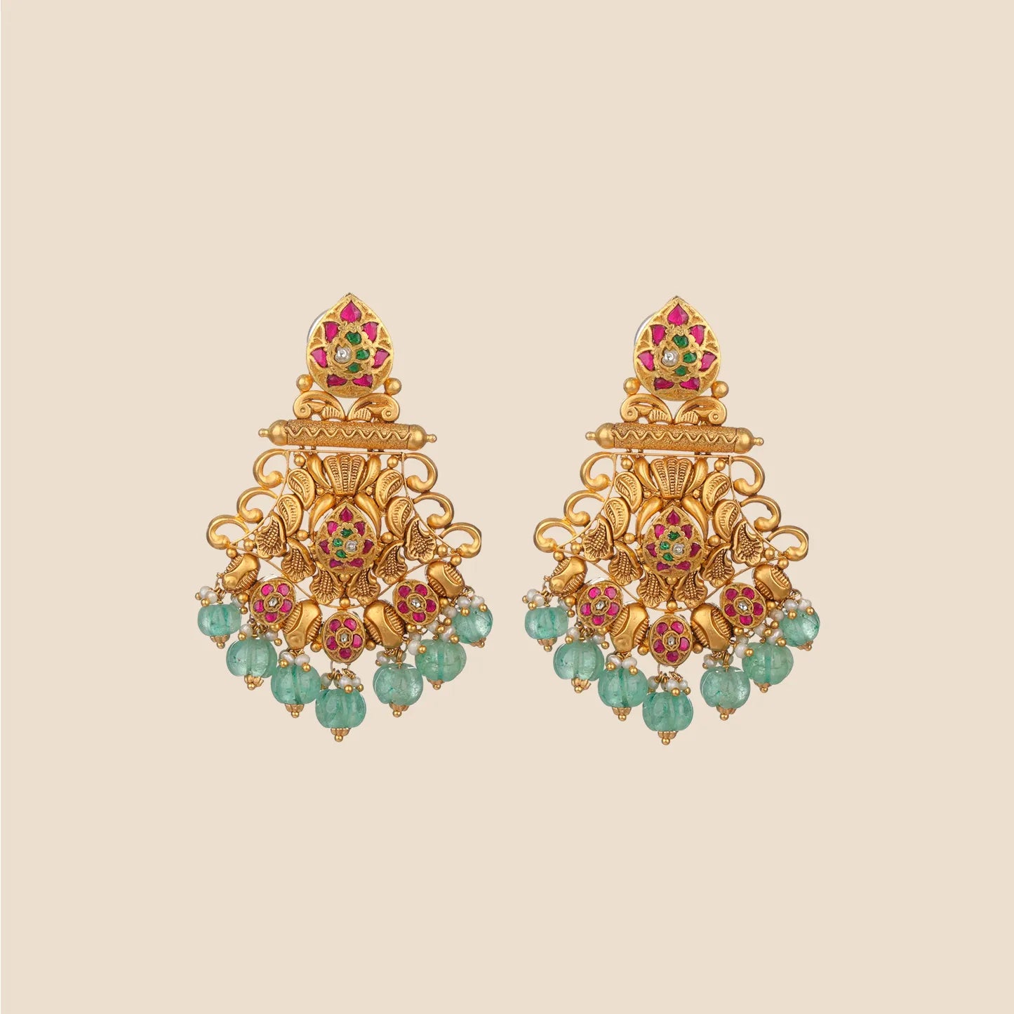 Ornate gold dangle earrings featuring floral and leaf motifs accented with pink and green stones, finished with hanging light green beads.