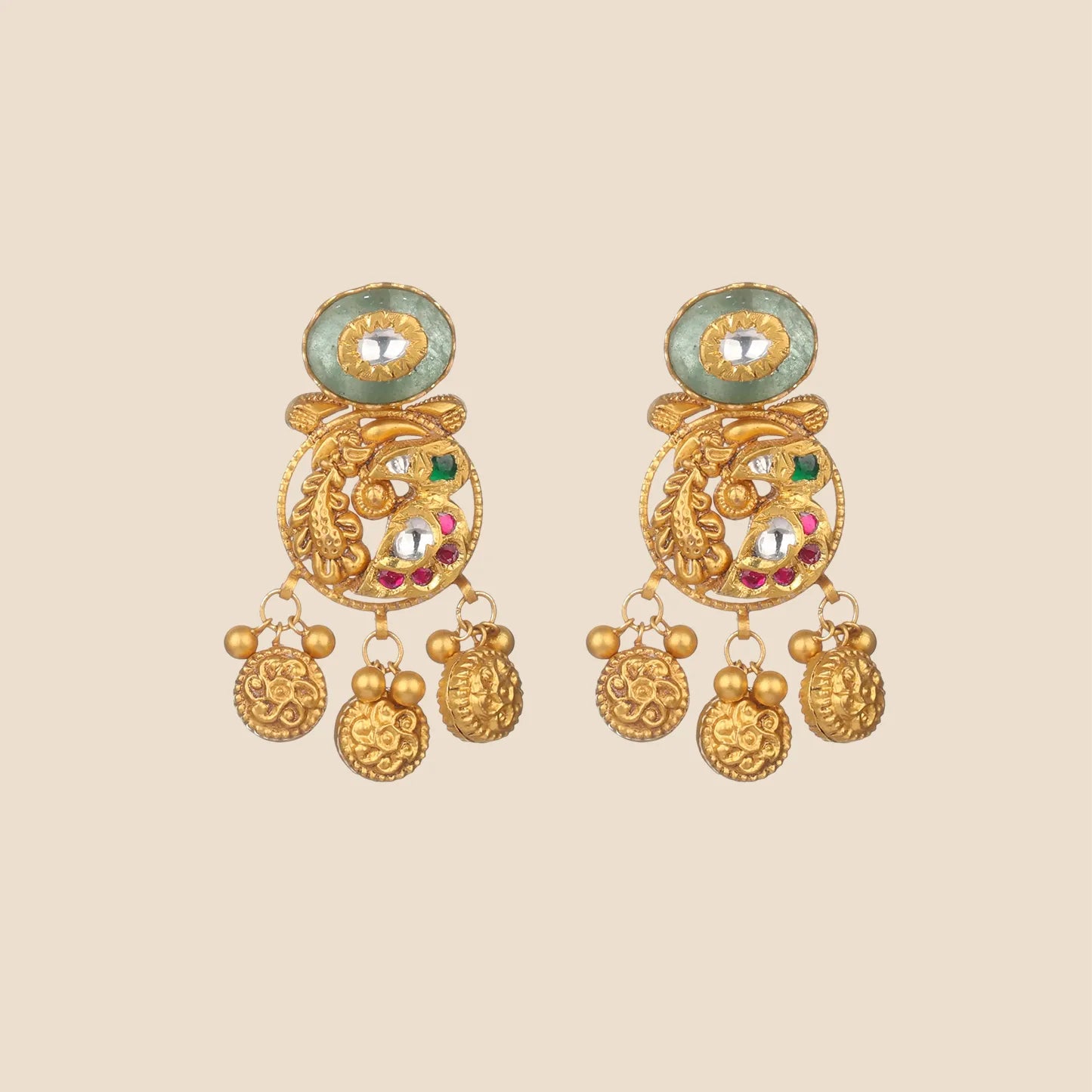 Gold earrings with emerald and ruby accents, horseshoe motifs, and dangling coin charms.