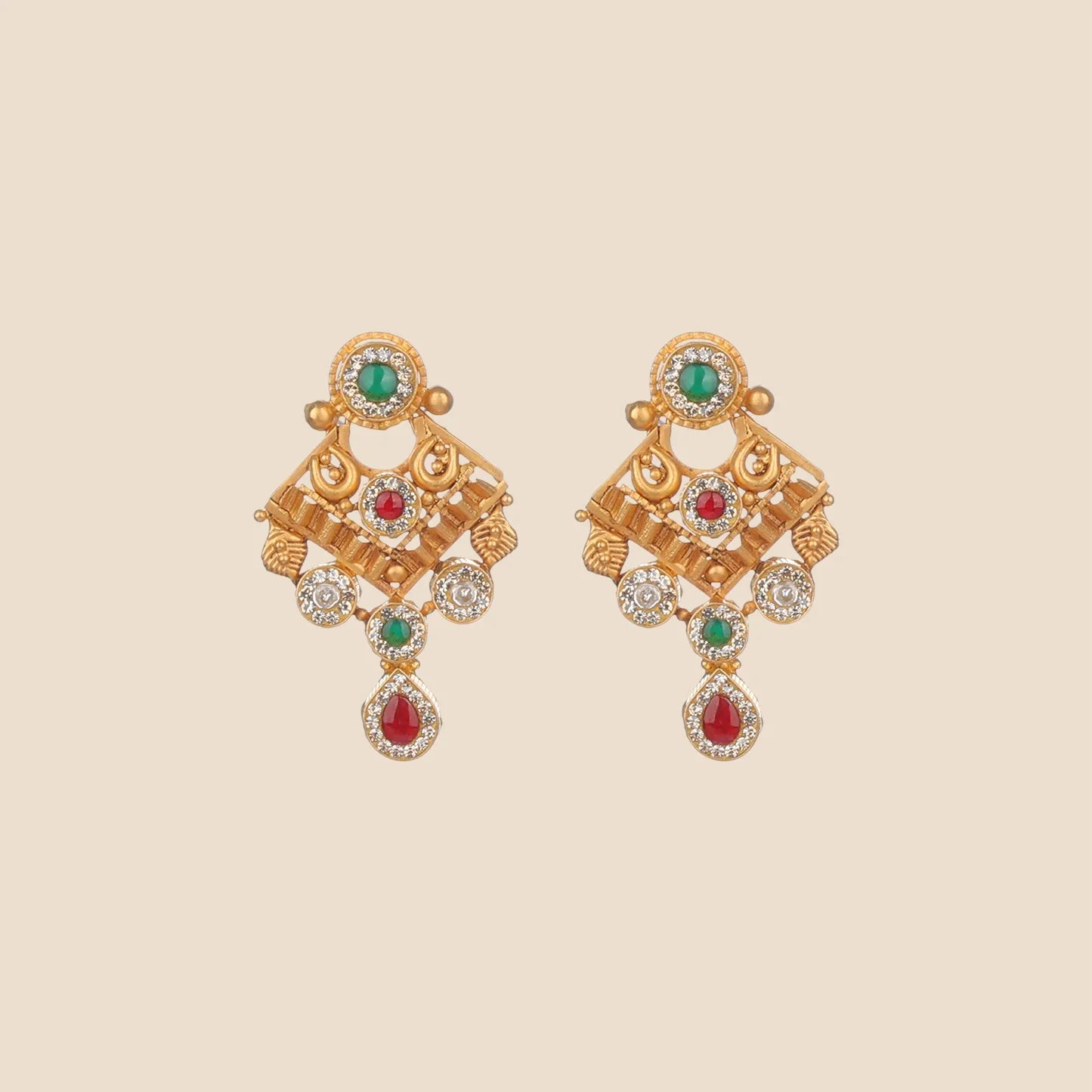 Gold dangle earrings featuring a green stone stud, a geometric diamond-shaped centerpiece with a central red stone, clear stone clusters, and a red teardrop dangle.