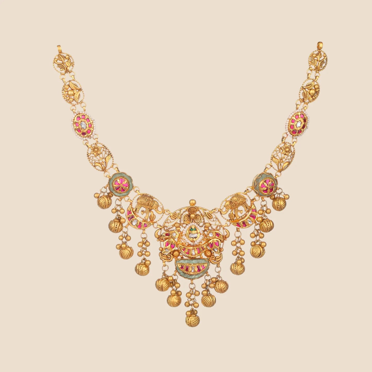 Gold choker necklace with emerald stone motifs, winged accents, and dangling temple-style charms.