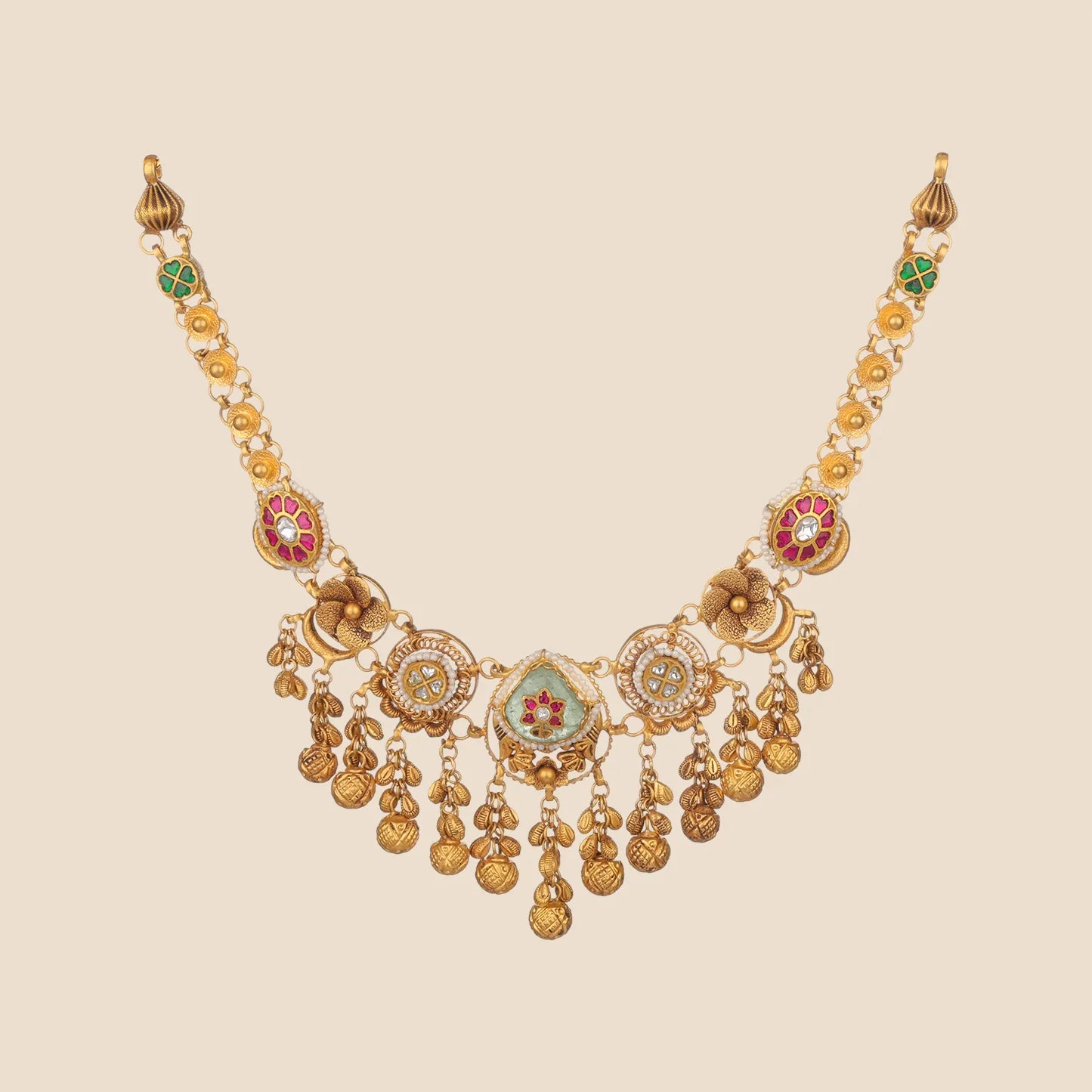 Gold choker necklace featuring a chain detailed with green and pink floral motifs, leading to a complex centerpiece with a green teardrop inset, circular side elements, and a fringe of textured gold drops.
