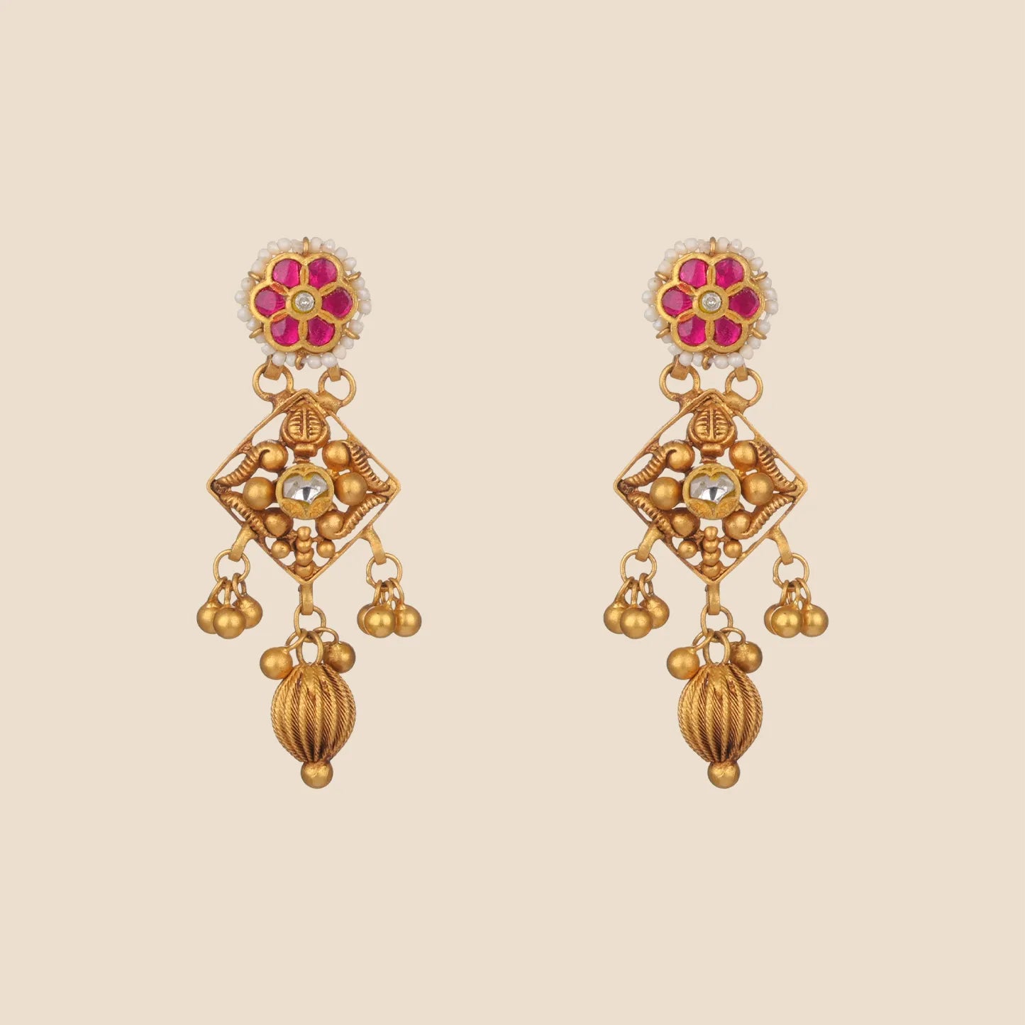 A pair of matching gold drop earrings featuring a ruby pink floral stud and a diamond-shaped gold frame with dangling textured beads.