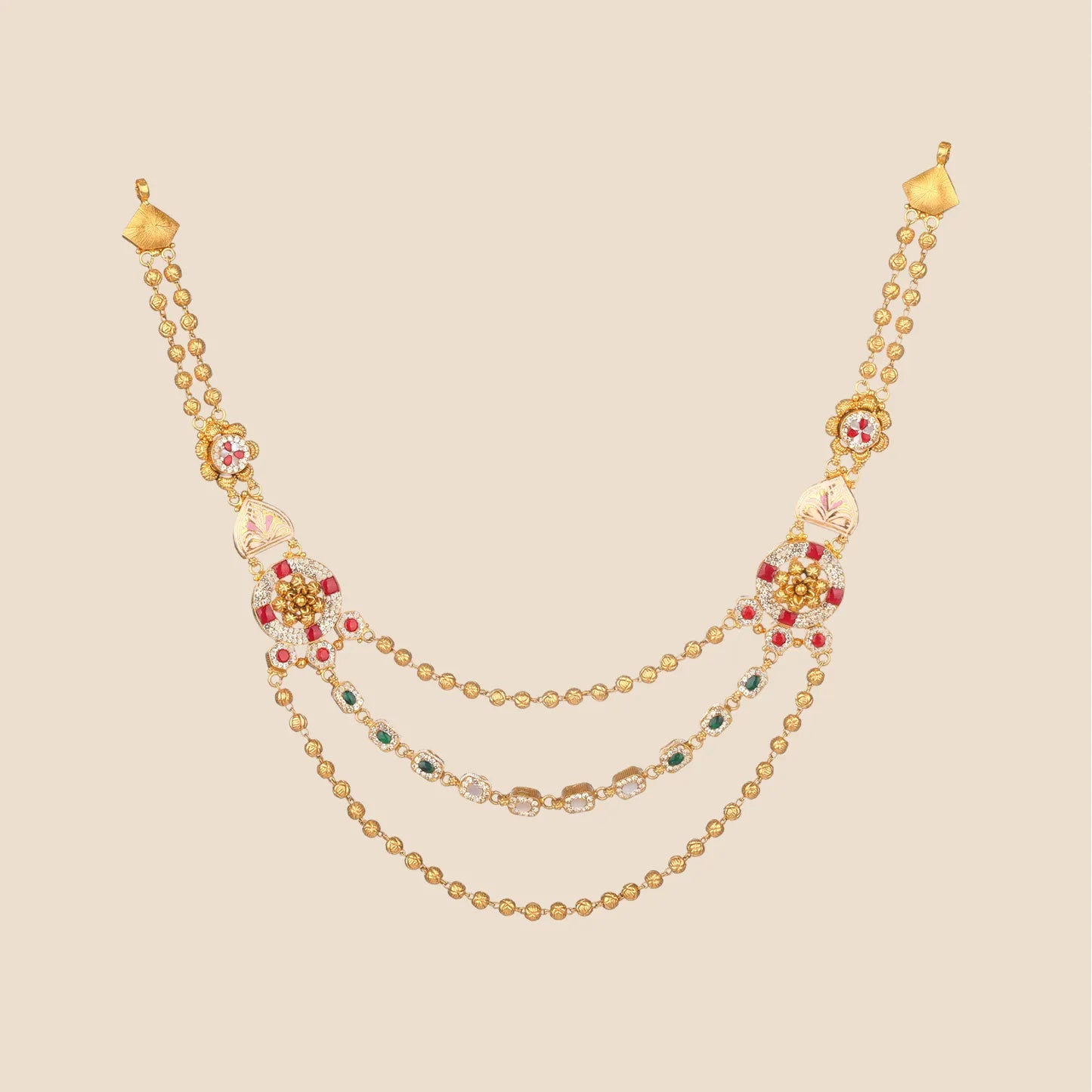 Layered gold necklace featuring ornate side motifs with white and pink enamel, red and clear stones, connected by three draped chains including one detailed with alternating green and clear stones.