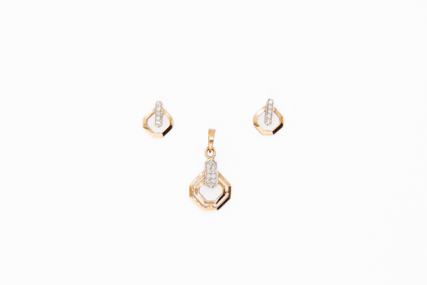Gold jewelry set with pendant and earrings on a white background