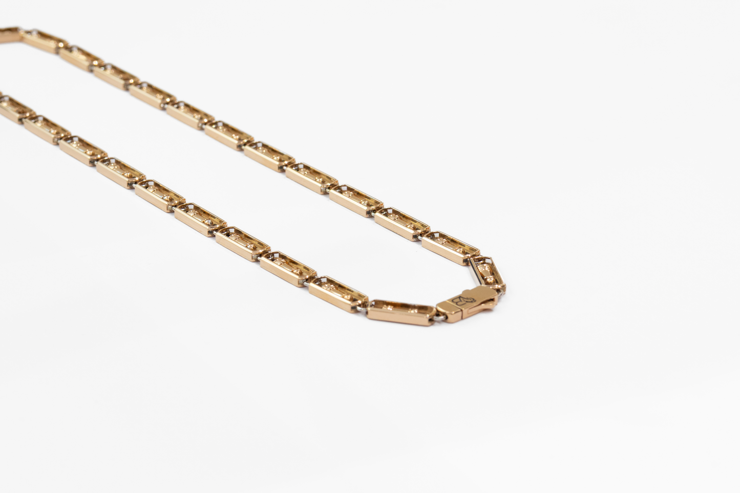 Gold chain necklace on a white background