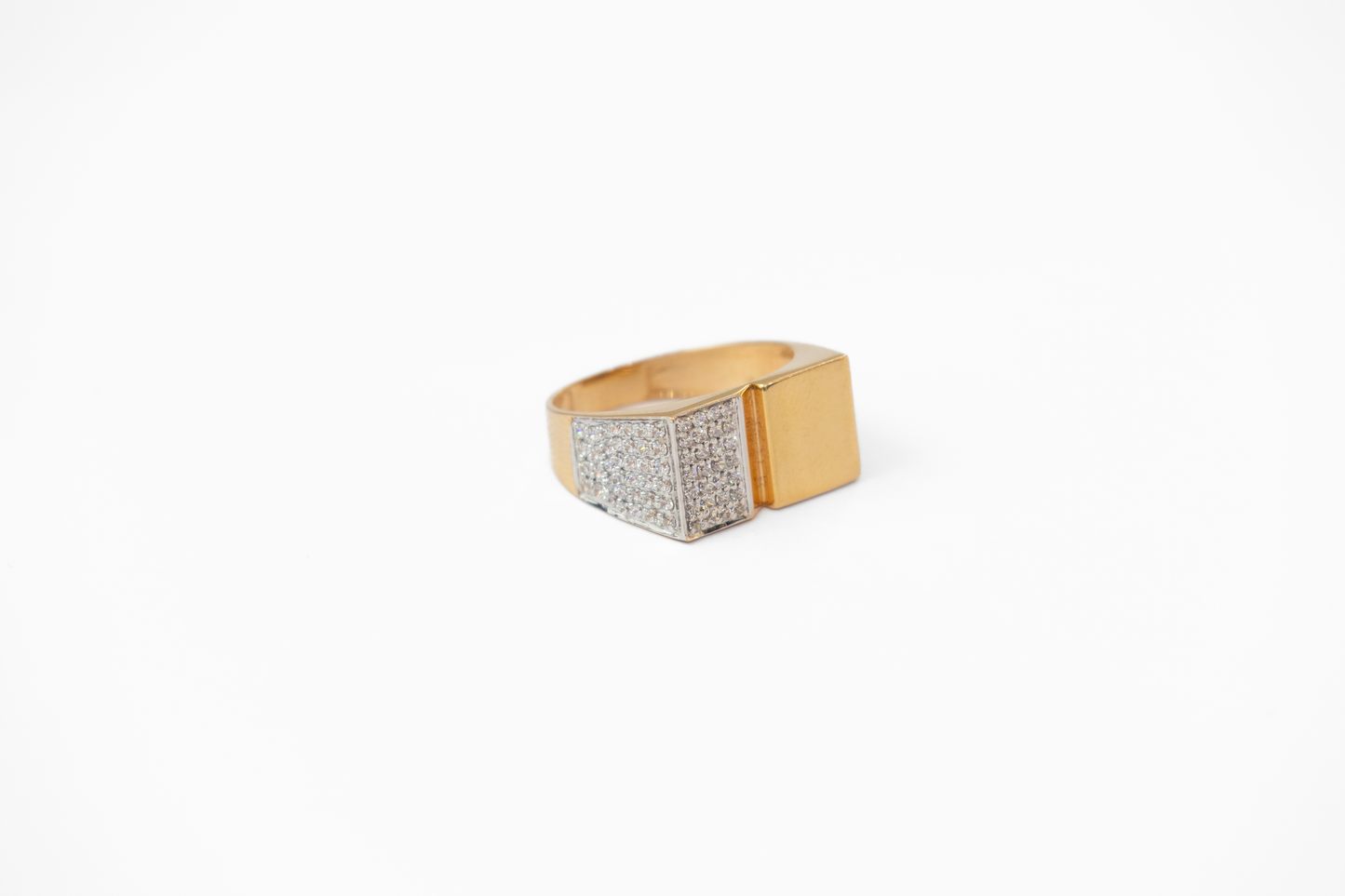 Gold ring with a diamond-studded band on a white background