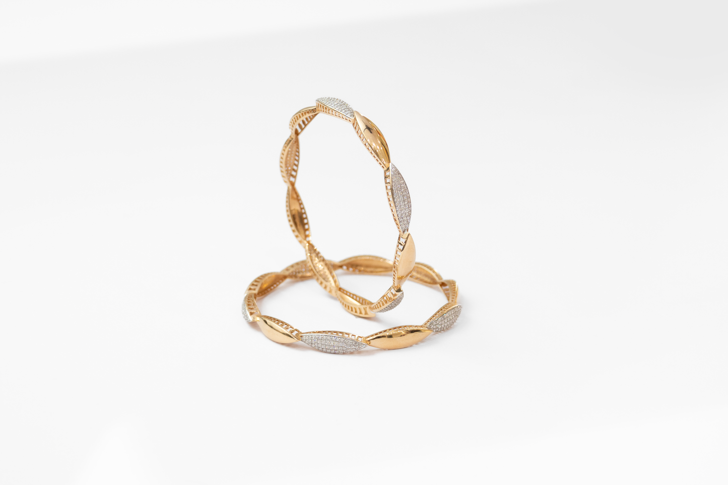 Women's Gold and silver bangles on a white background