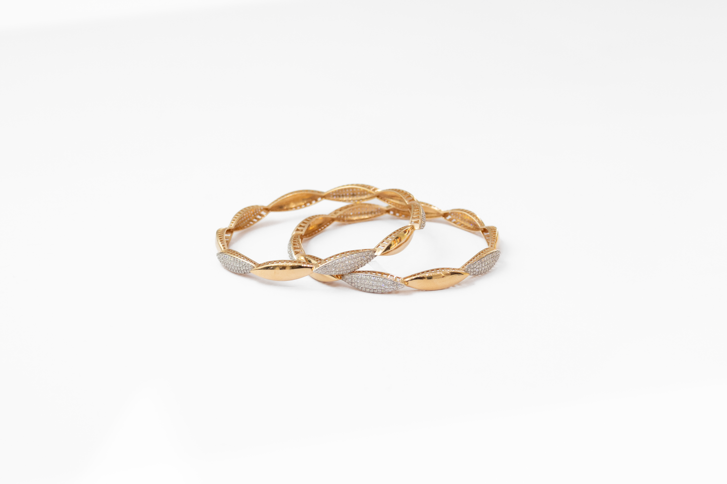 Gold and silver bangles on a white background