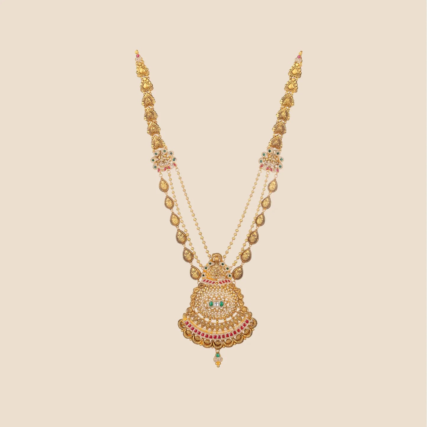 Long traditional gold necklace with a multi-layered chain and a large, intricate pendant detailed with red and green stones.