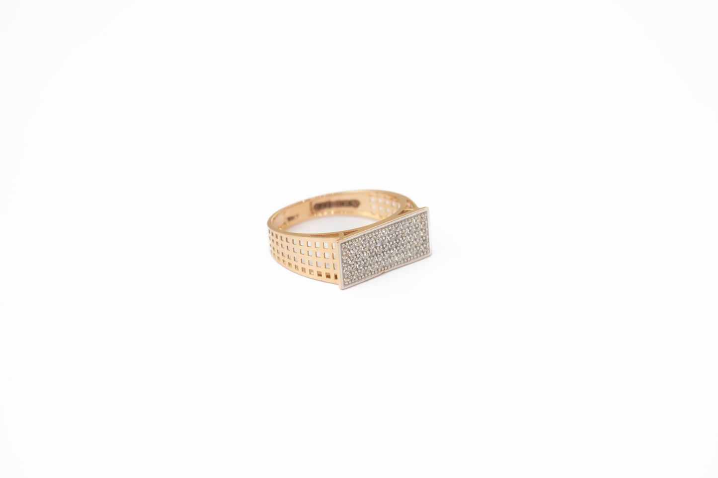 Gold ring with diamond accents on a white background