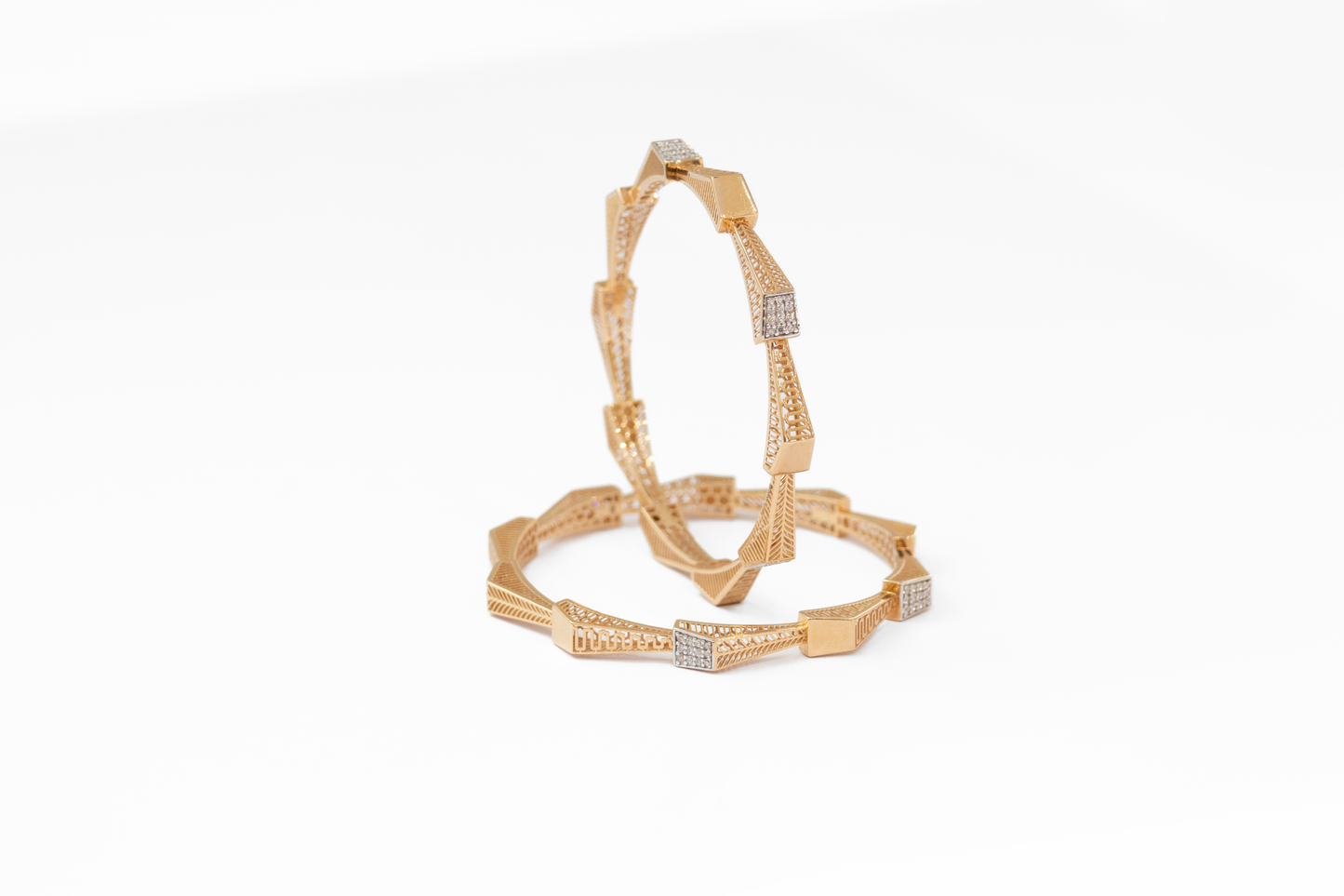 Women Gold bangles with diamond accents on a white background
