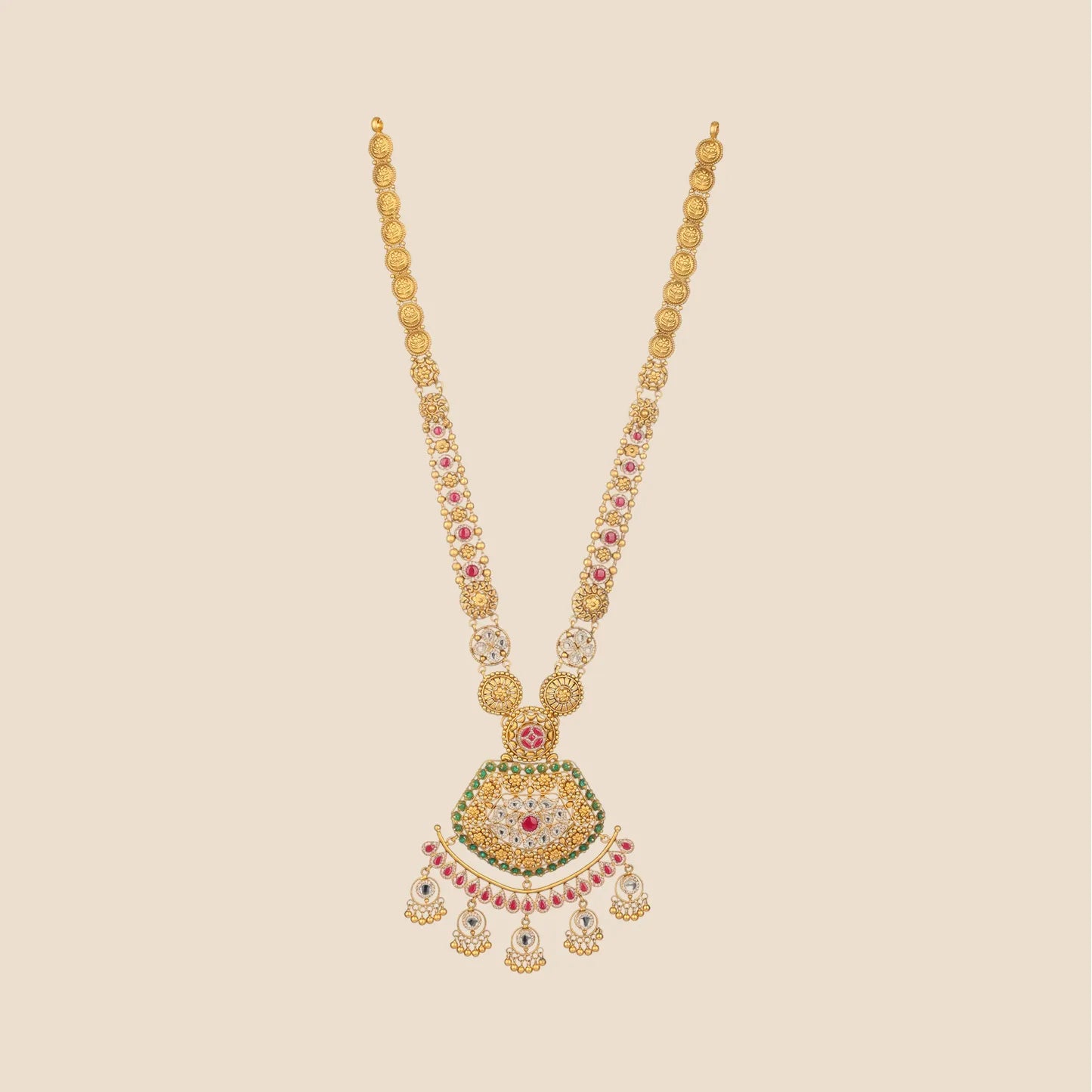 Long gold necklace with a beaded chain and a large ornate pendant detailed with green and red stones, featuring a wide crescent-shaped drop with hanging gold beads.