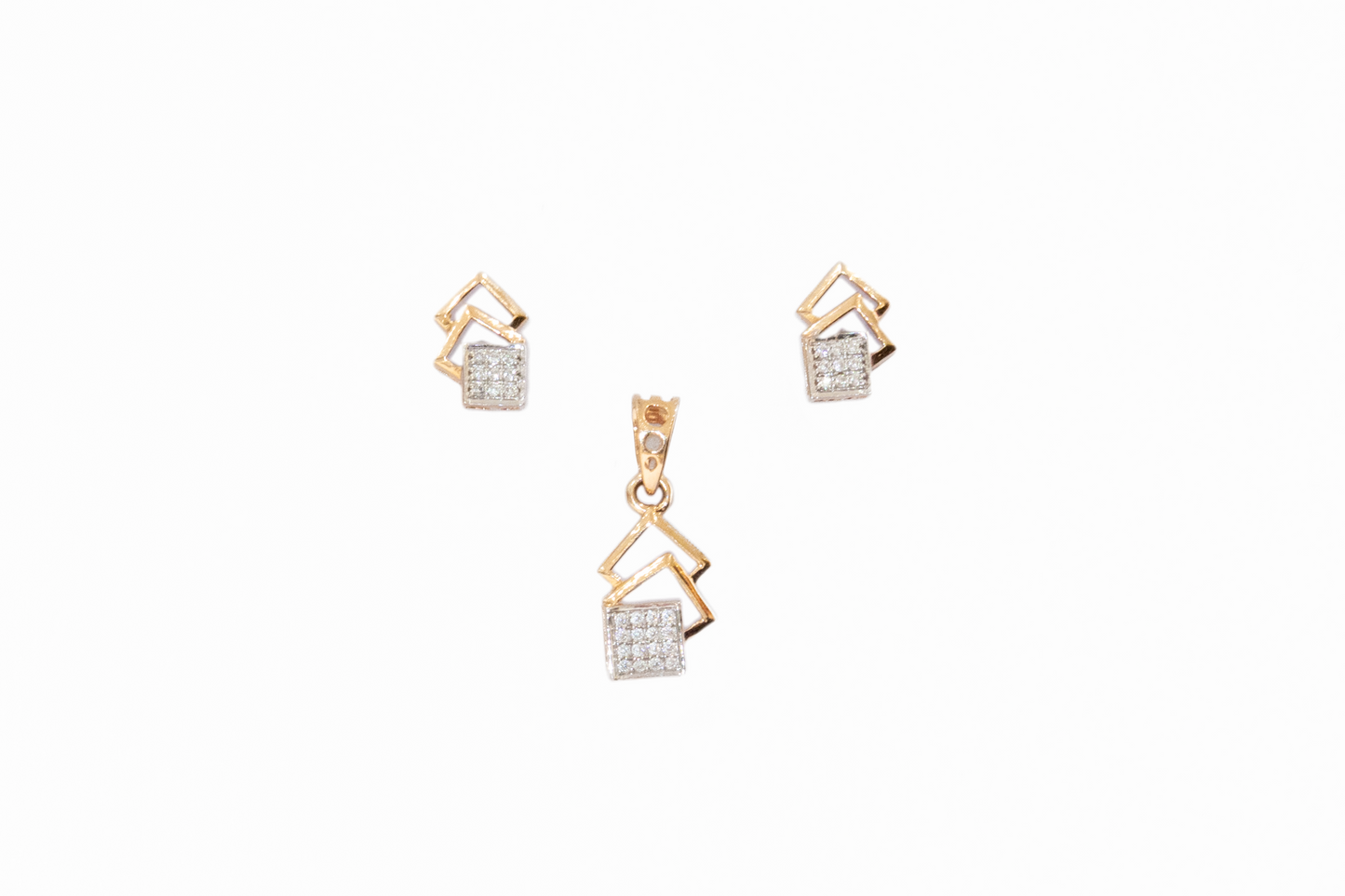 Gold jewelry set with pendant and earrings on a white background