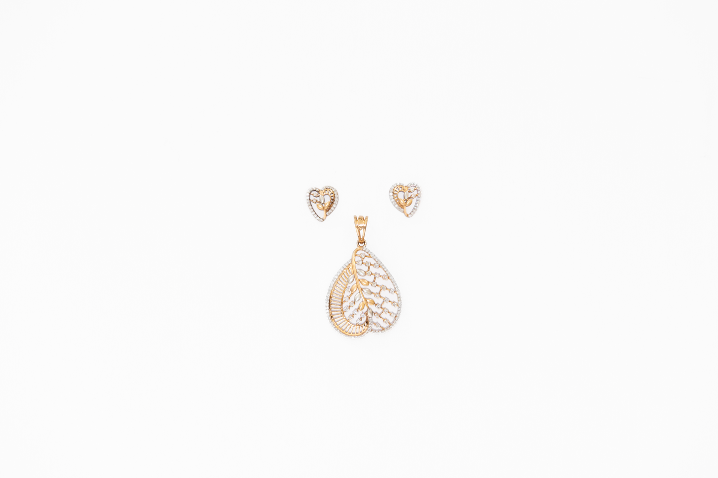 Gold teardrop pendant and heart-shaped earrings on a white background