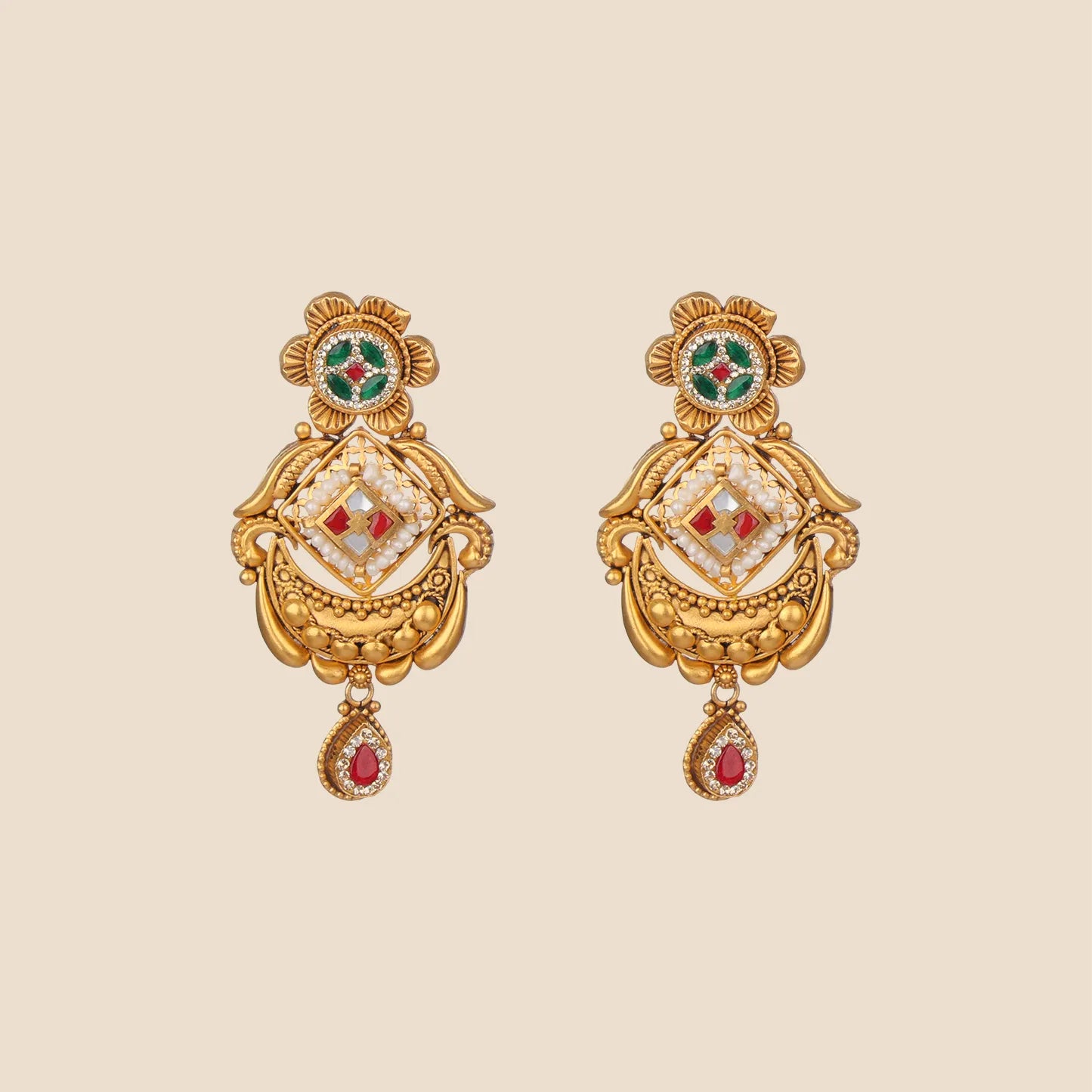 A pair of matching gold drop earrings featuring floral studs with green enamel and crescent-shaped bases accented by red stones and pearls.