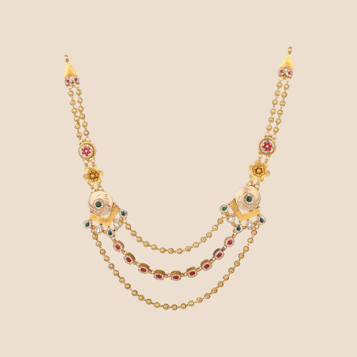 Layered gold necklace with three draped beaded chains, featuring enameled side motifs and interspersed red and green stone accents.