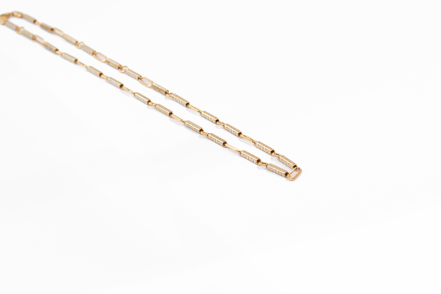 Gold chain necklace on a white background