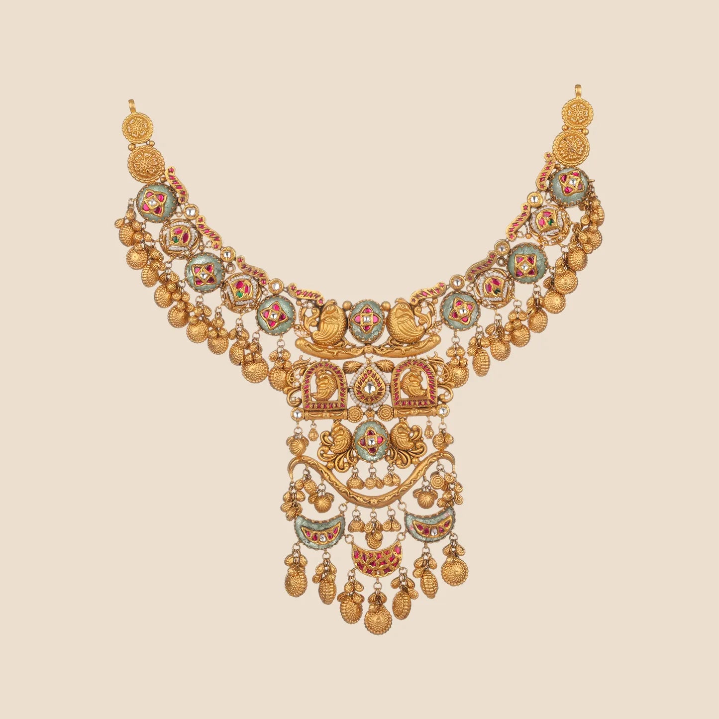 A sophisticated gold choker necklace featuring a central emerald gemstone, red floral stone accents, and detailed filigree work with hanging gold beads.