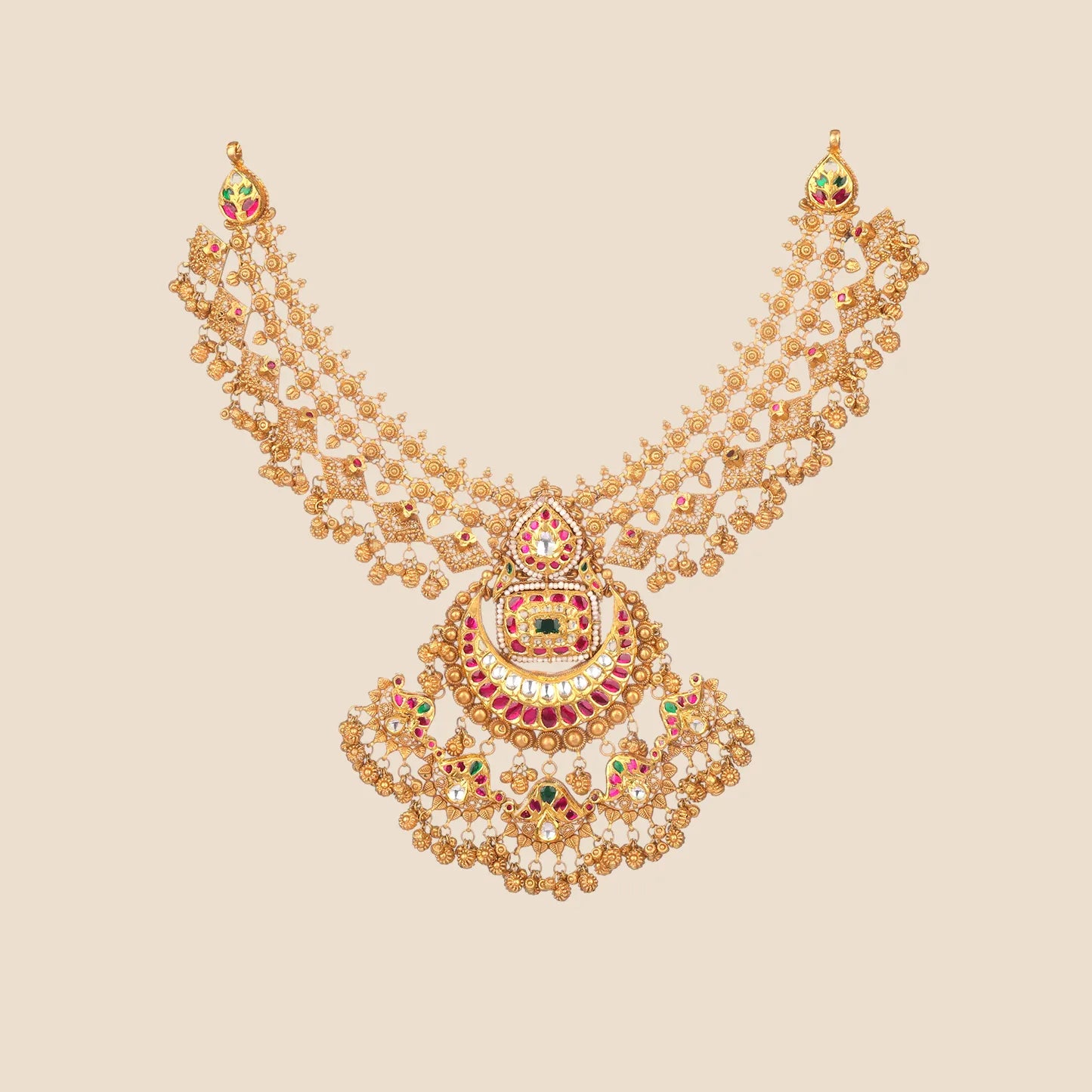Intricate gold choker necklace featuring an elaborate multi-tiered pendant adorned with red and green stones and multiple hanging gold bead drops.