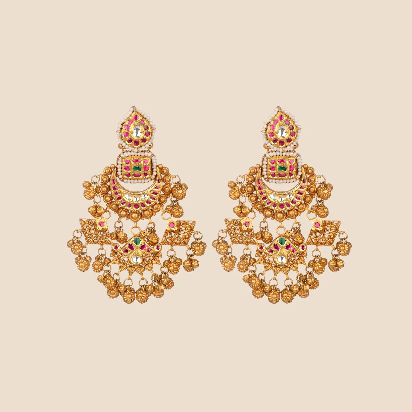 Ornate gold dangle earrings featuring tiered crescent and geometric motifs with red and green stones and hanging gold beads.