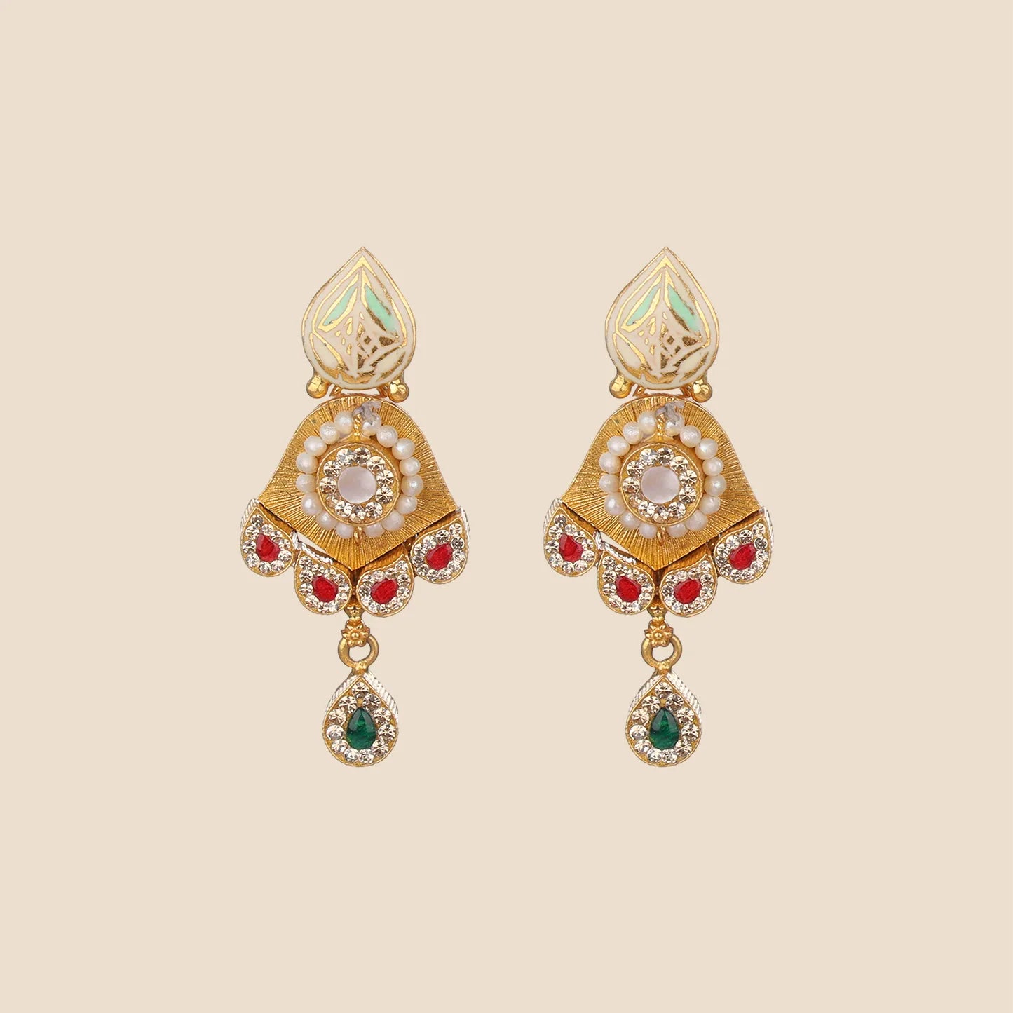 Ornate gold dangle earrings featuring a cream enameled top, a central white stone surrounded by pearls, red stone accents along the bottom edge, and a hanging green teardrop.