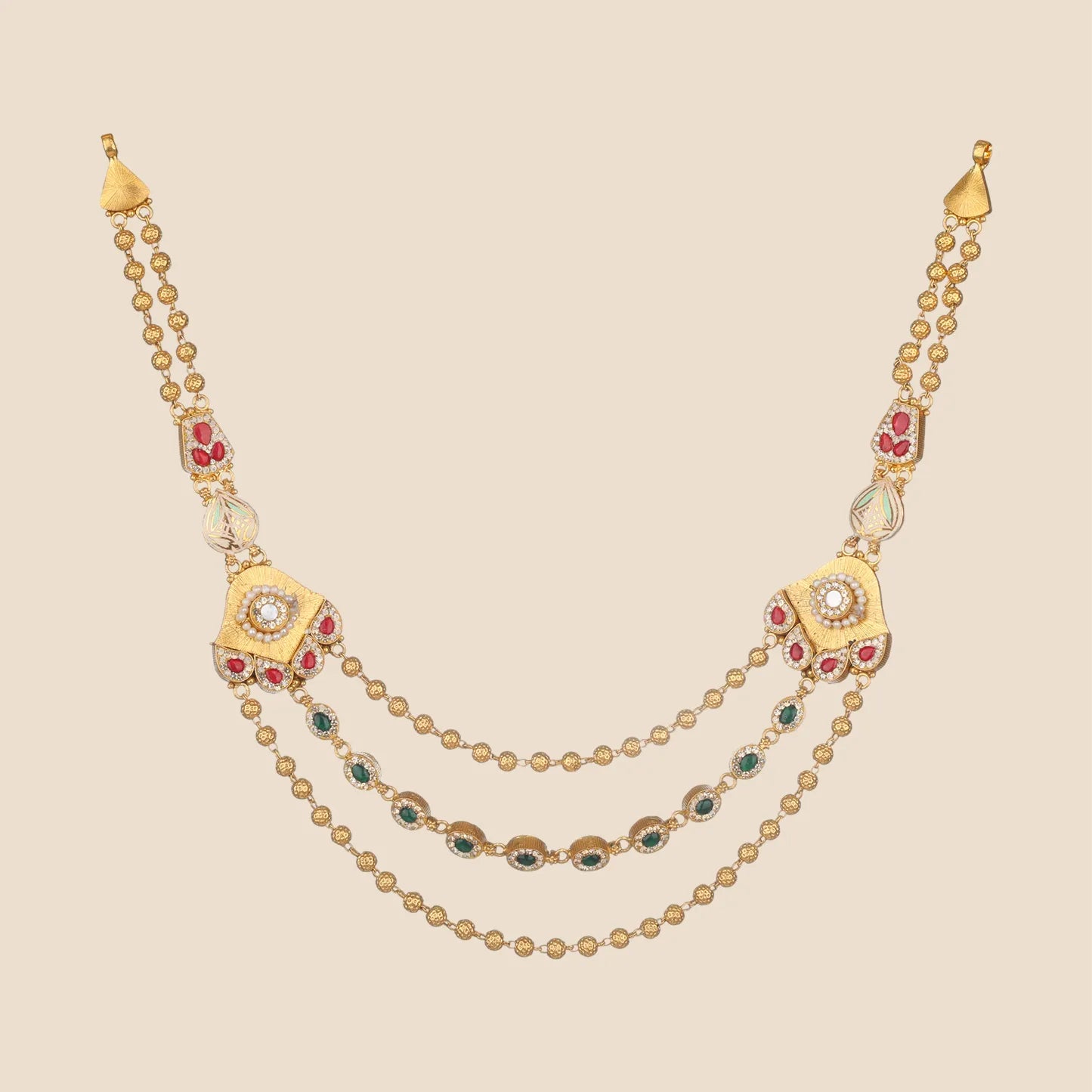Layered gold necklace featuring ornate side motifs with pearls and red stones, connected by three draped beaded chains, including a middle chain accented with green stones.