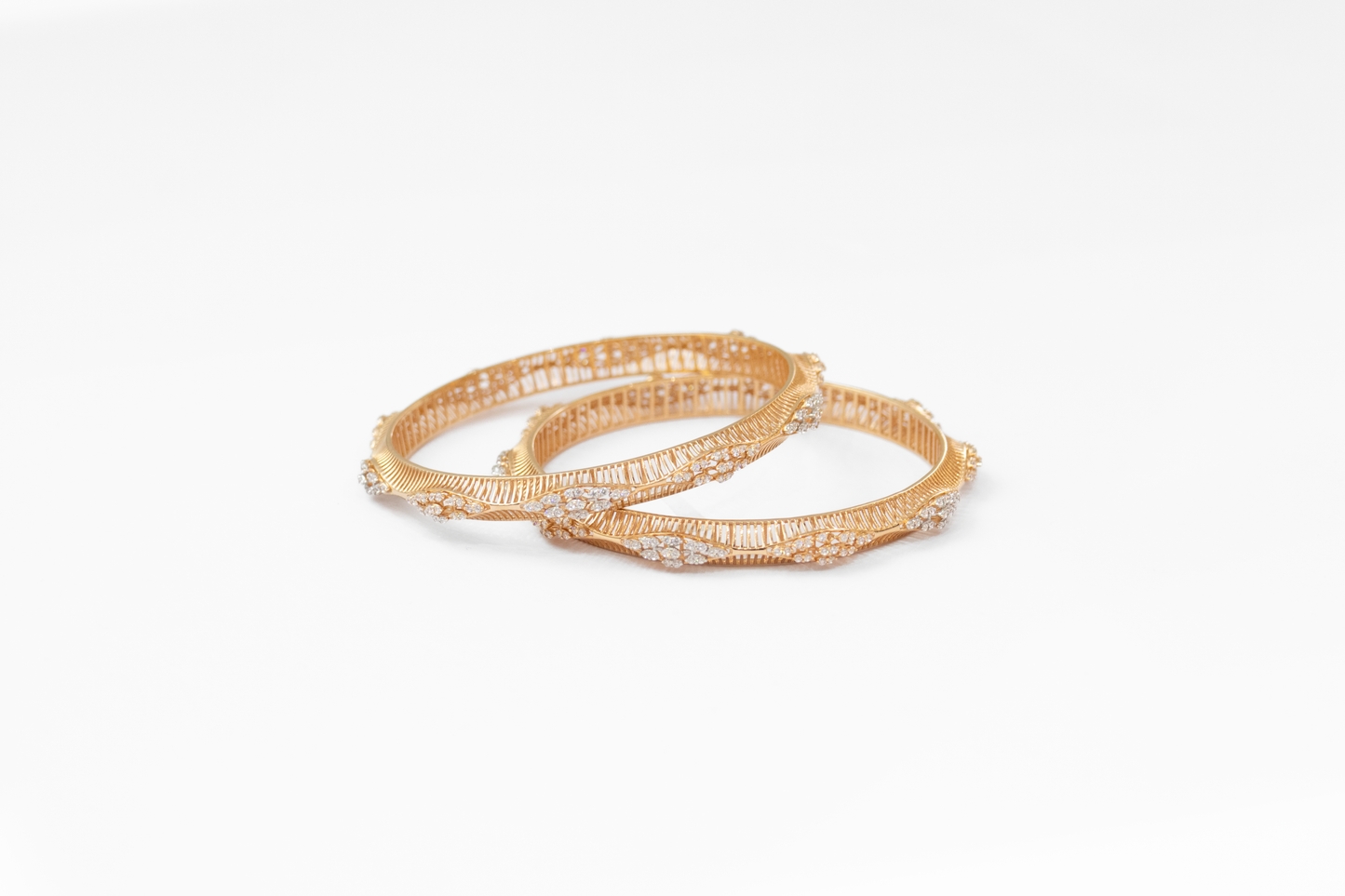 Gold bangles on a white background