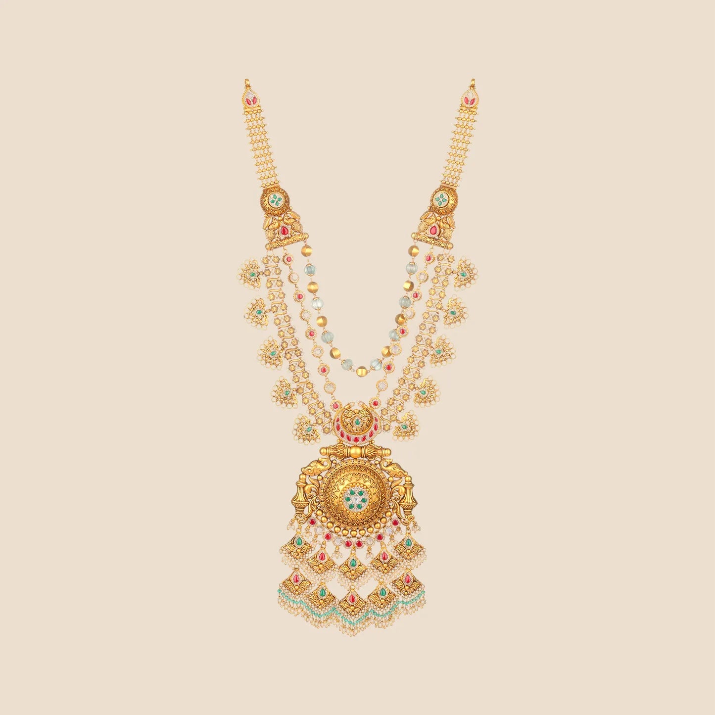 Antique gold long temple necklace featuring elephant motifs, multi-strand pearl and emerald chains, and a large ornate pendant with ruby, emerald, and pearl tassel drops.