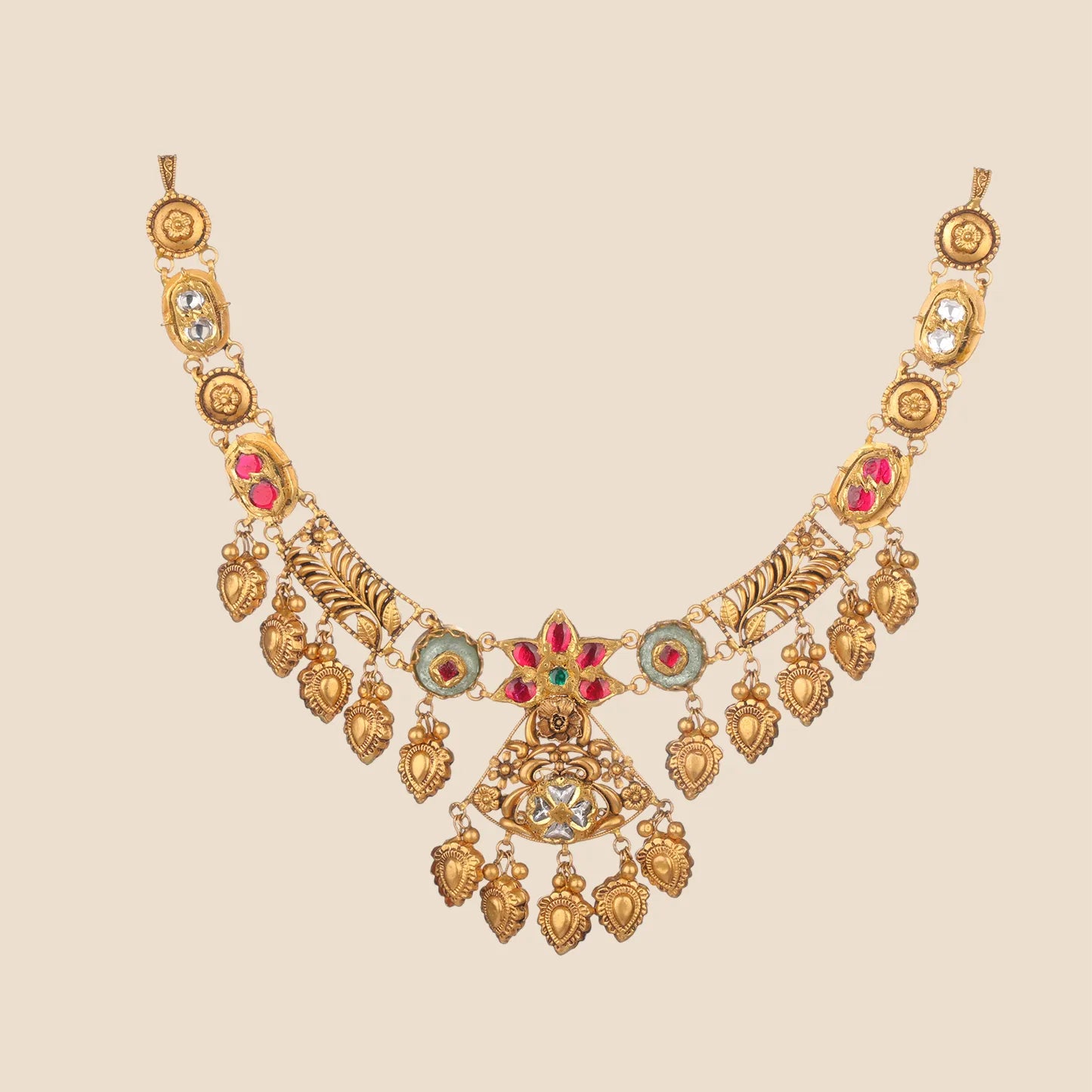 A traditional gold choker necklace featuring a star-shaped center with red stones, floral filigree, and multiple dangling gold leaf charms.