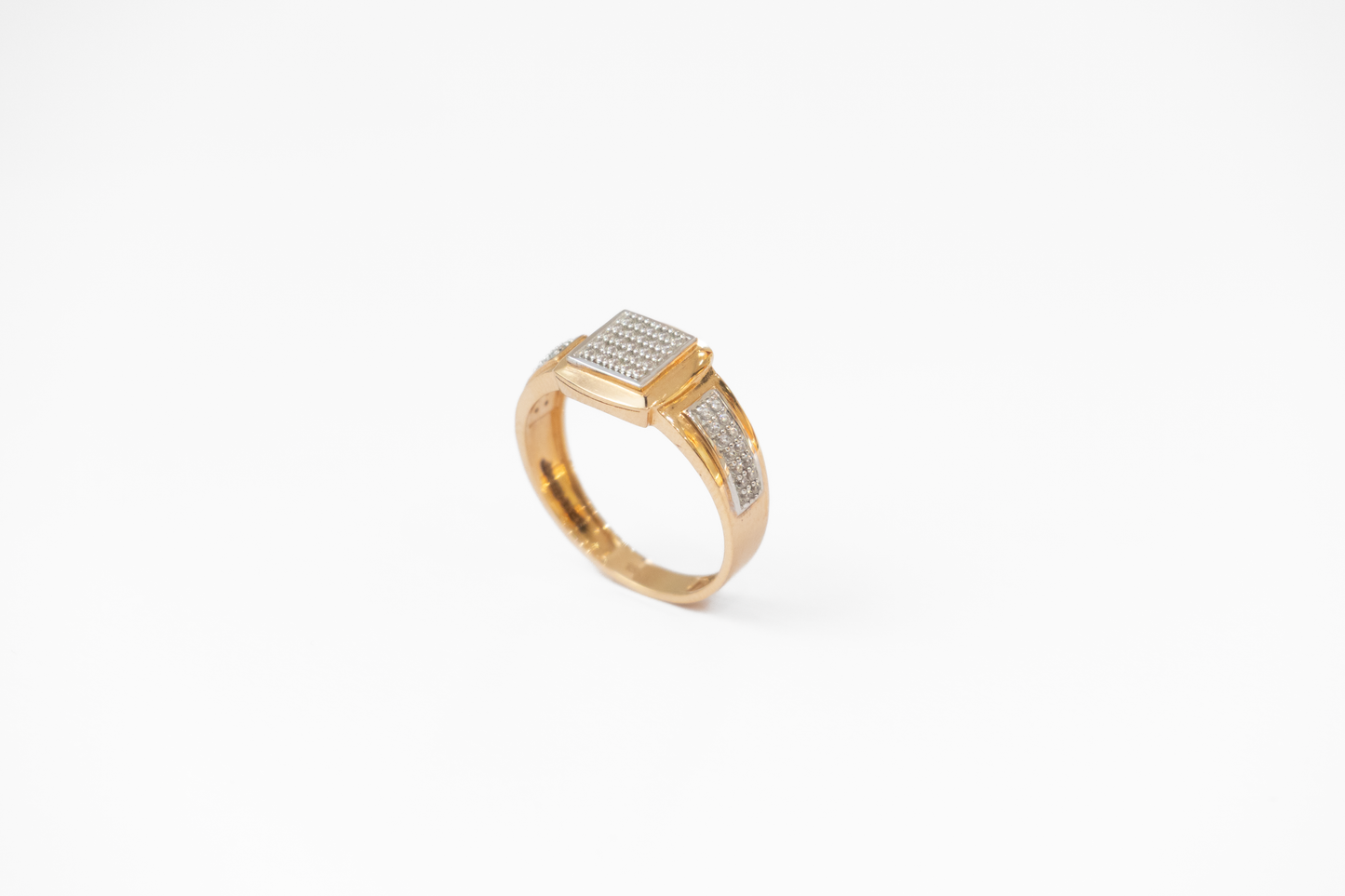 Gold ring with diamond accents on a white background