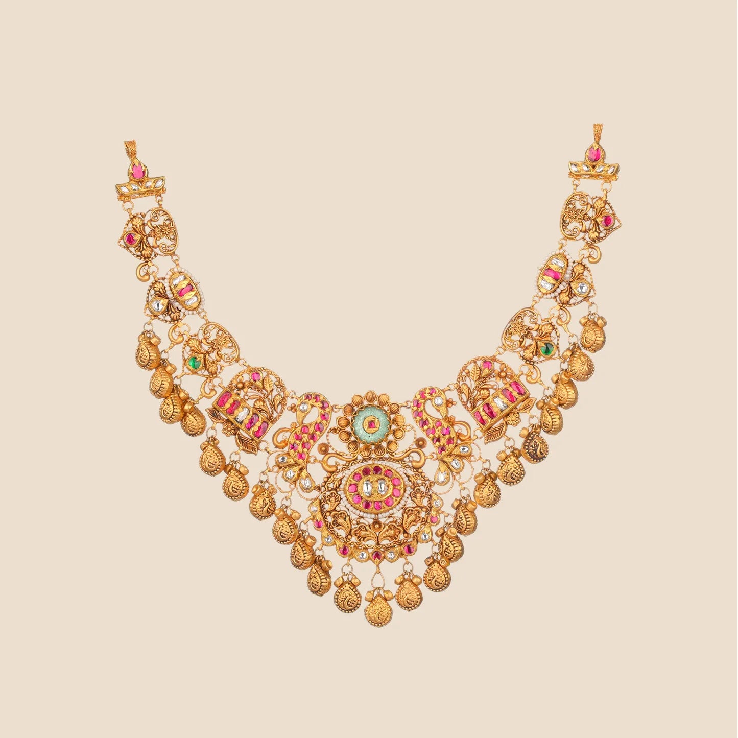 Elaborate gold choker necklace featuring a central green stone, surrounded by red stones, pearls, and multiple ornate hanging dangles.