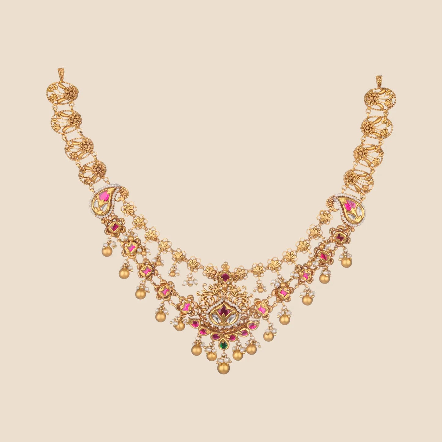 Traditional gold choker necklace featuring floral and leaf chain links leading to a complex filigree centerpiece adorned with pink stones, tiny pearls, and hanging gold spheres.