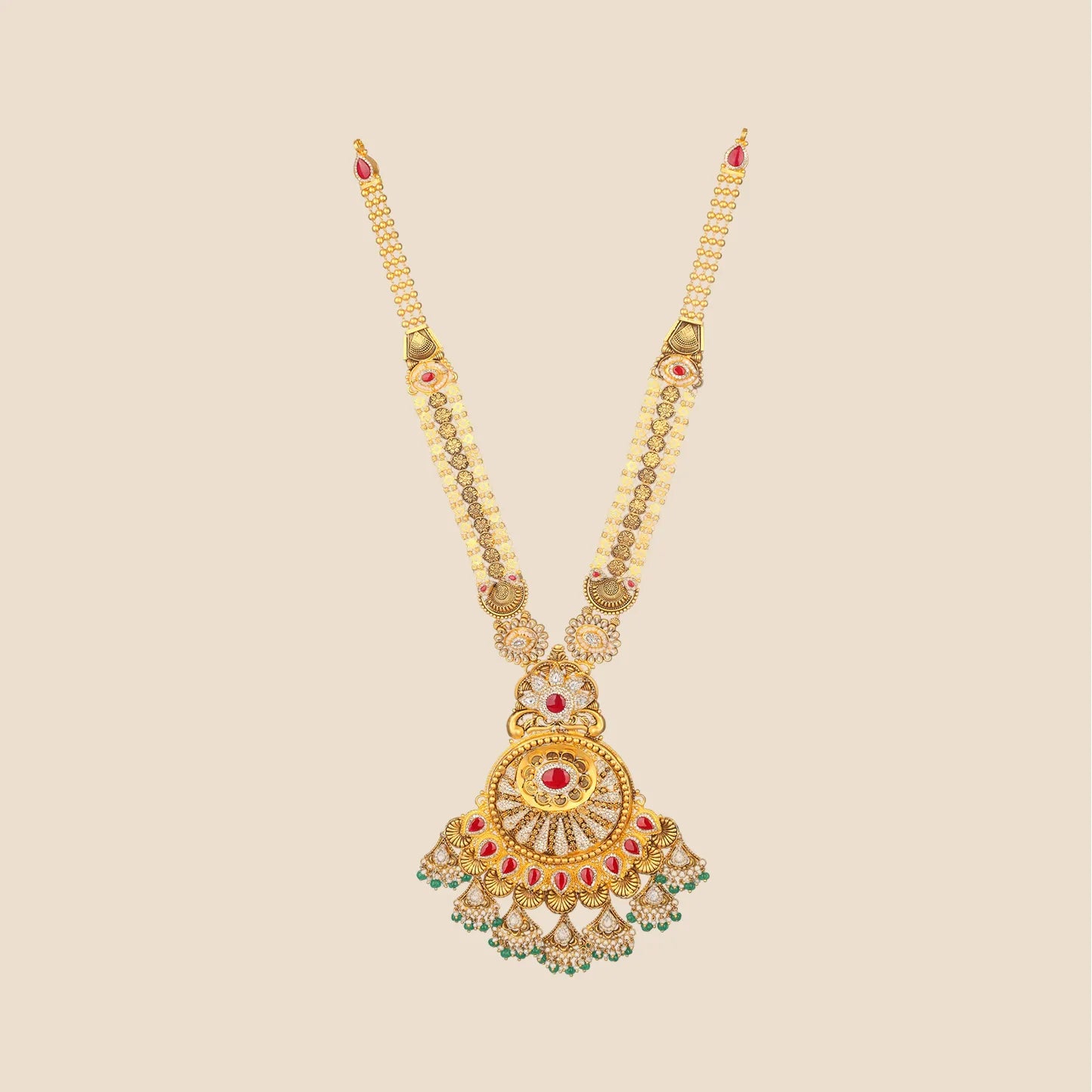 Long traditional gold necklace featuring a multi-strand beaded chain and a large, intricate circular pendant detailed with red stones, clear gems, and hanging green beads.