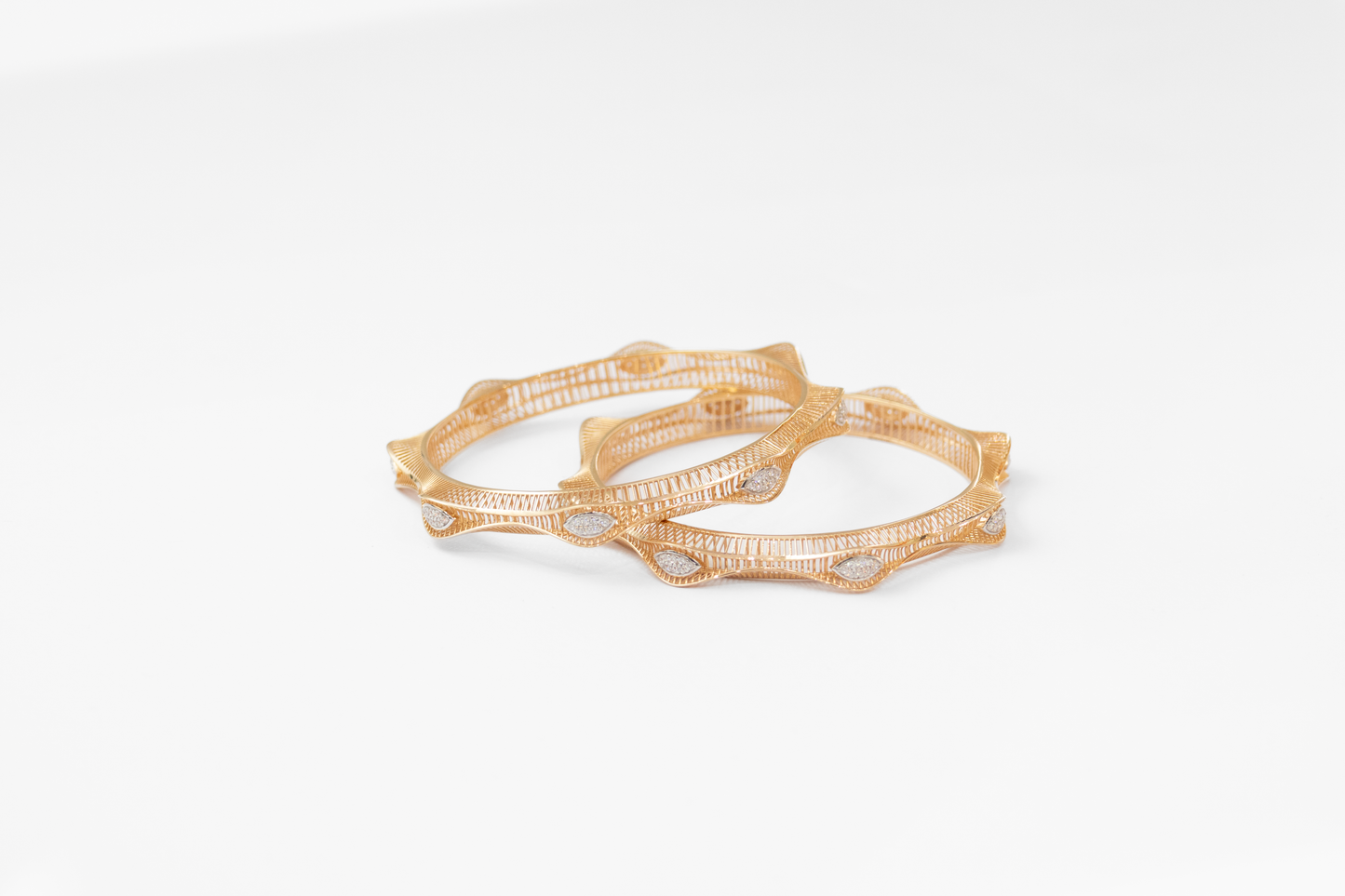 Women Gold bangles on a white background