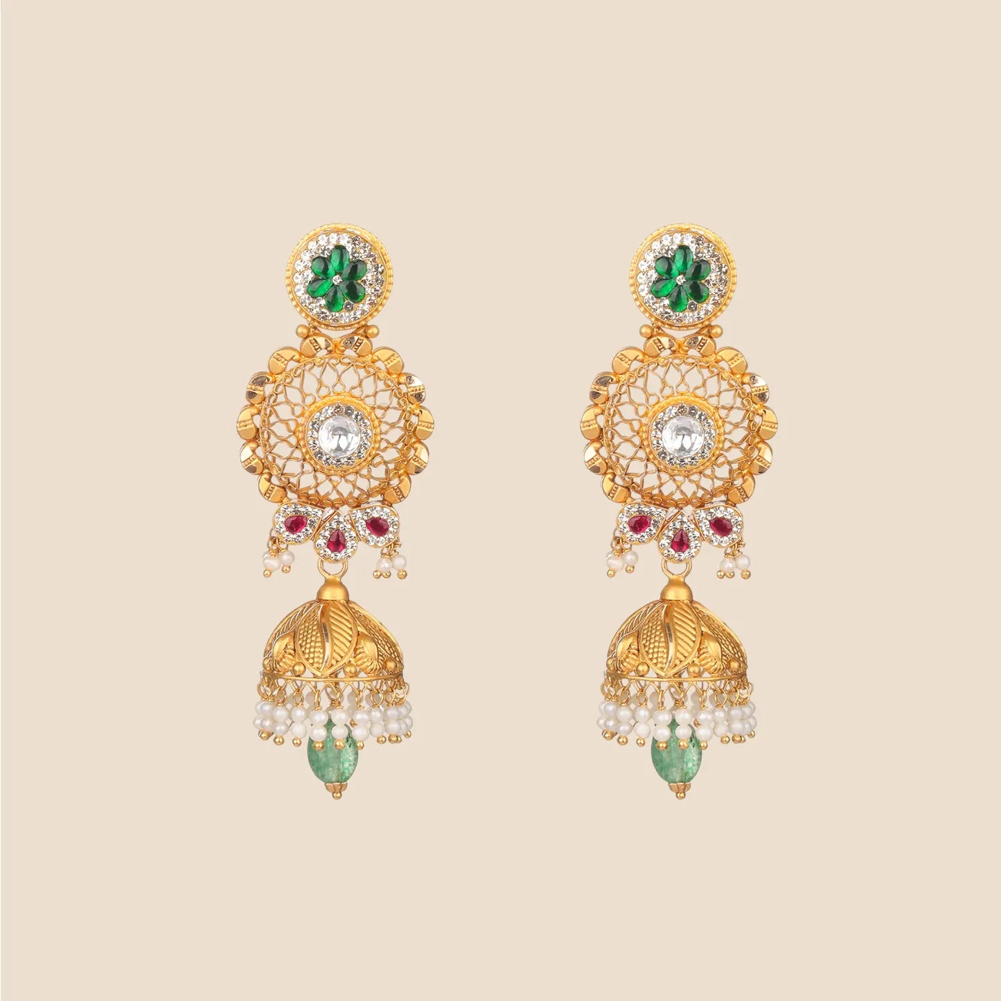 Gold jhumka earrings featuring a green floral stud, a central clear stone within a filigree circle, red stone accents, and a textured bell drop with pearl fringes and a dangling green bead.