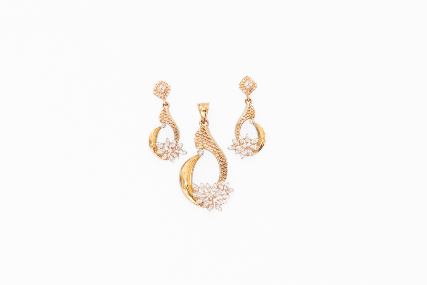 Pair of gold earrings with floral designs on a white background