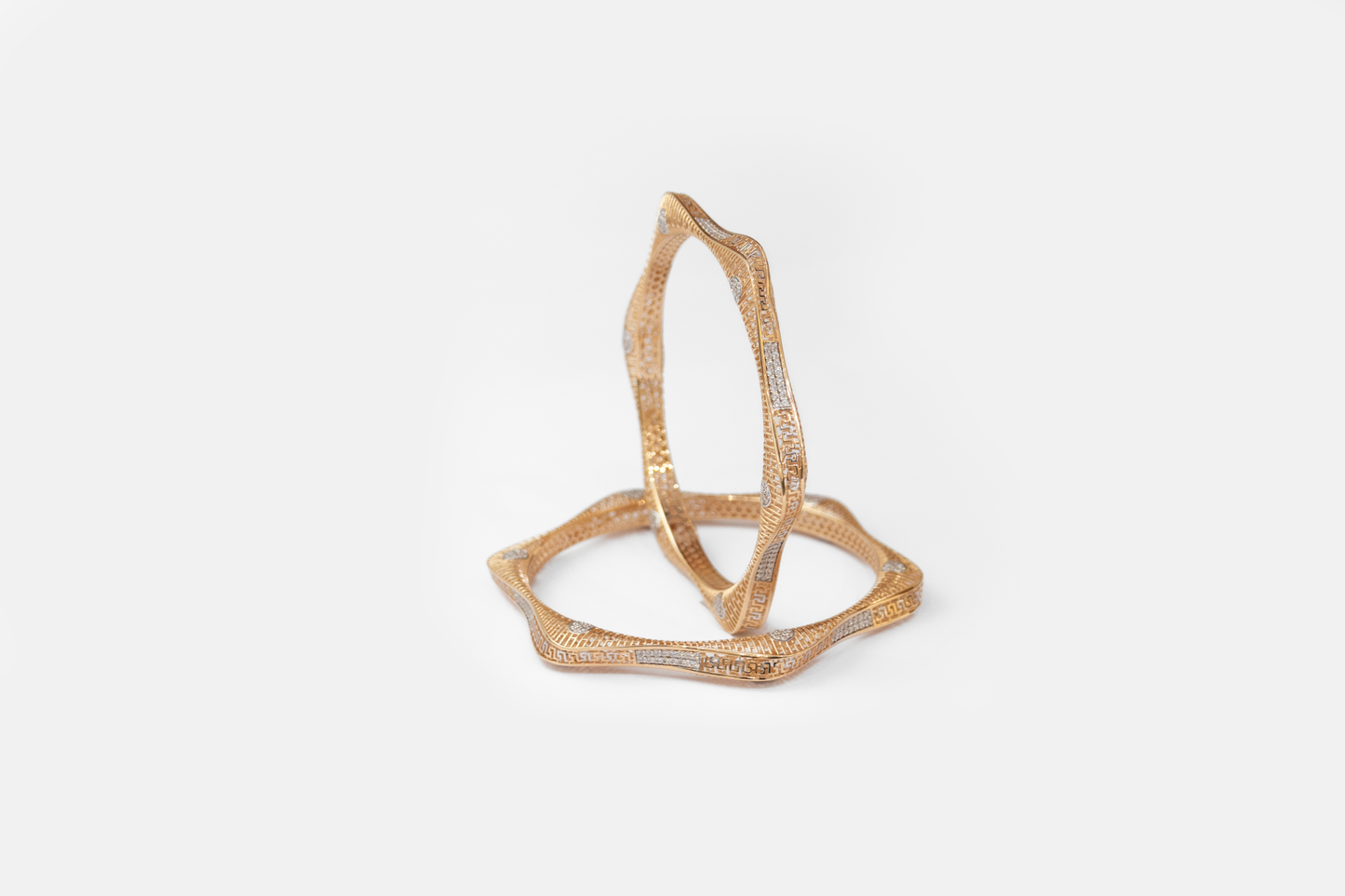 Gold geometric ring on a white background