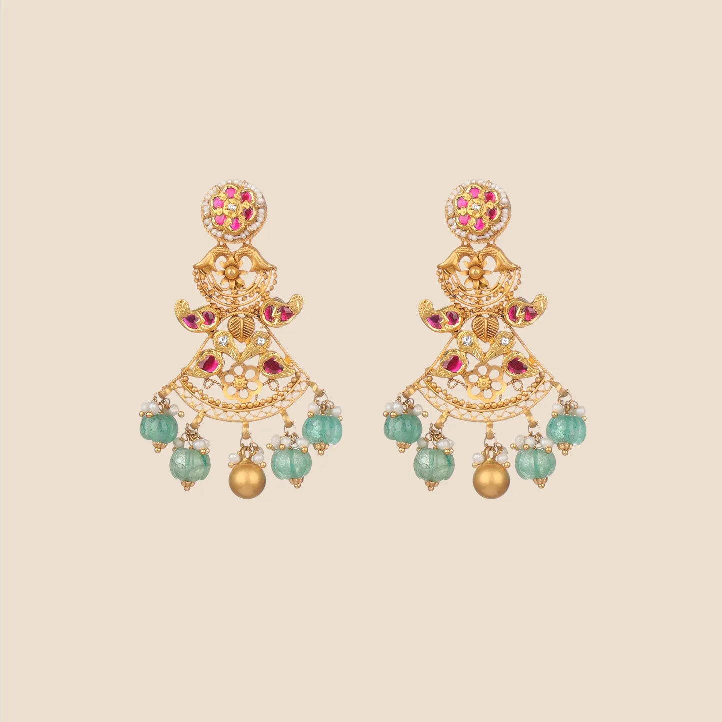 Gold dangle earrings with a round top featuring red stones, a central section with cut-out motifs and red accents, and hanging light green beads.