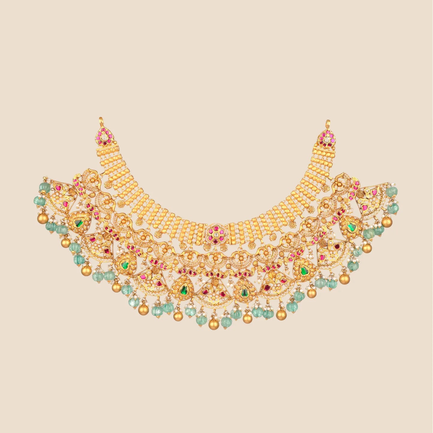 Elaborate gold choker necklace with multiple tiers, featuring intricate cut-out patterns, red and green stones, and a fringe of hanging light green beads and gold drops.